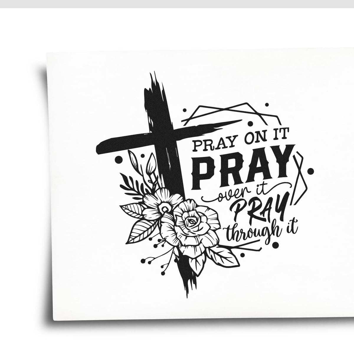 Black stamp and seal design with cross, floral accents, and Pray on it, pray over it, pray through it wording.
