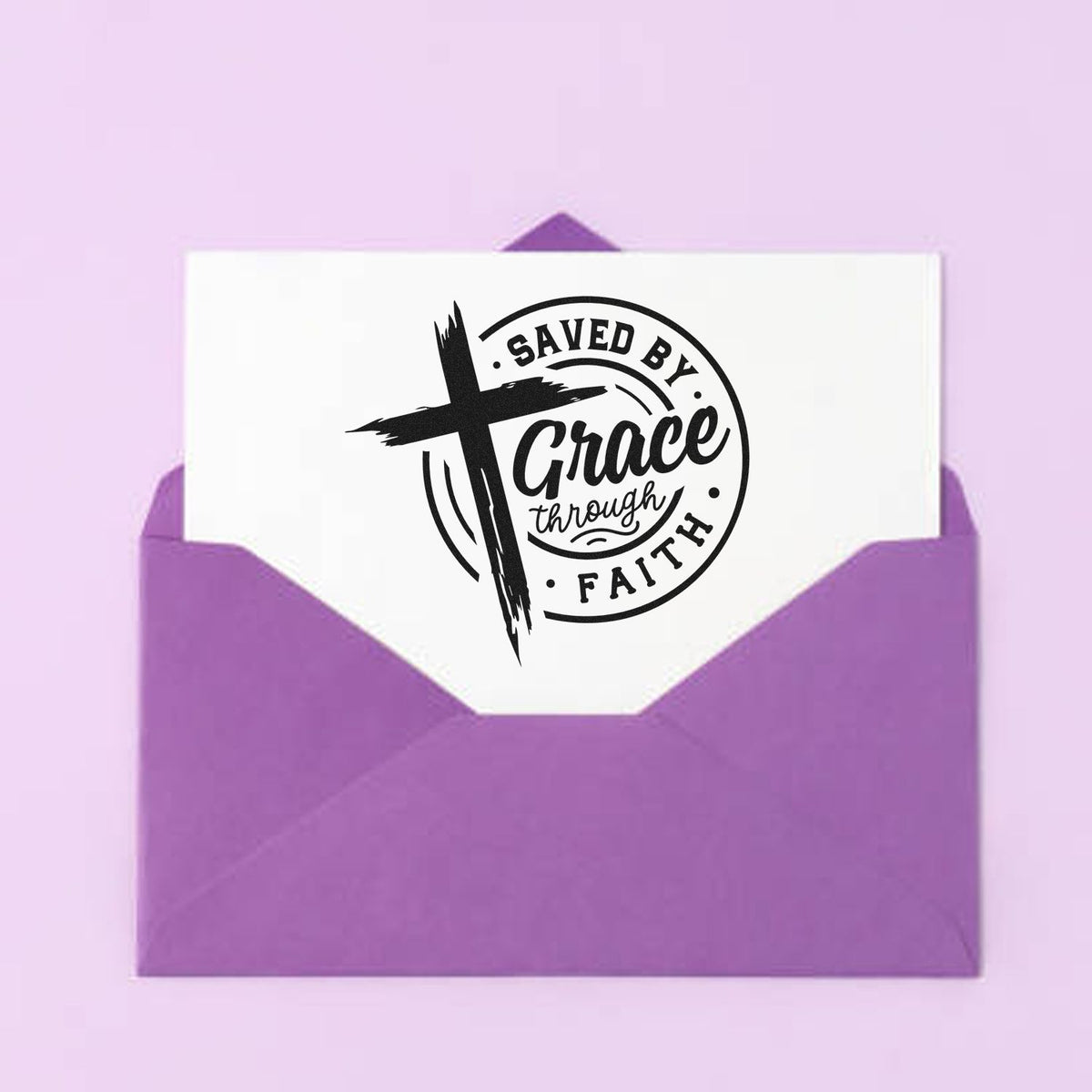 Premium Wooden Saved By Grace Through Faith Brushstroke Cross Stamp - Vintage Pro imprint stamped in black ink. A brushstroke cross overlaps a circular "Saved by grace through faith" design.