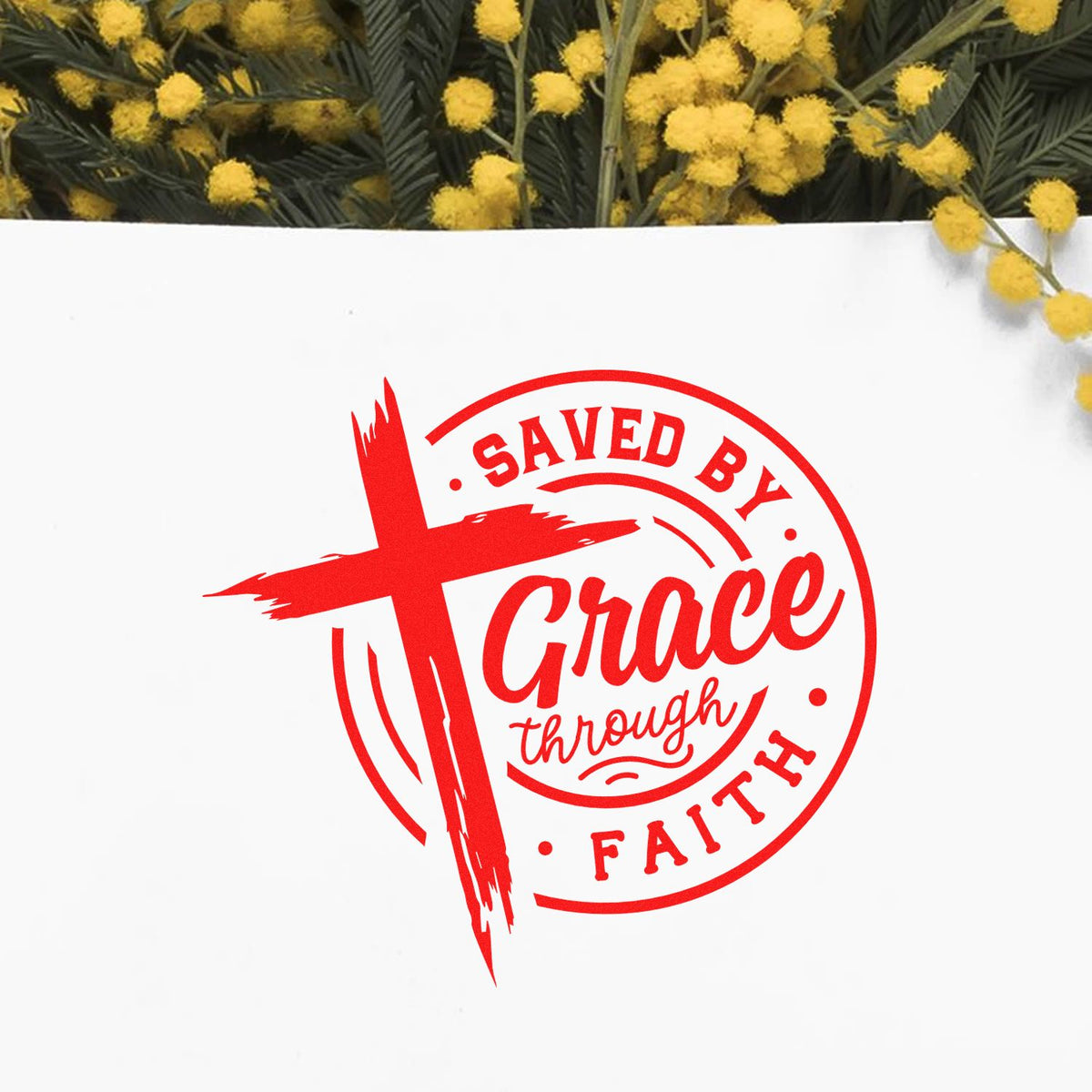 Red circular stamp seal with cross and Saved by Grace through Faith on white background
