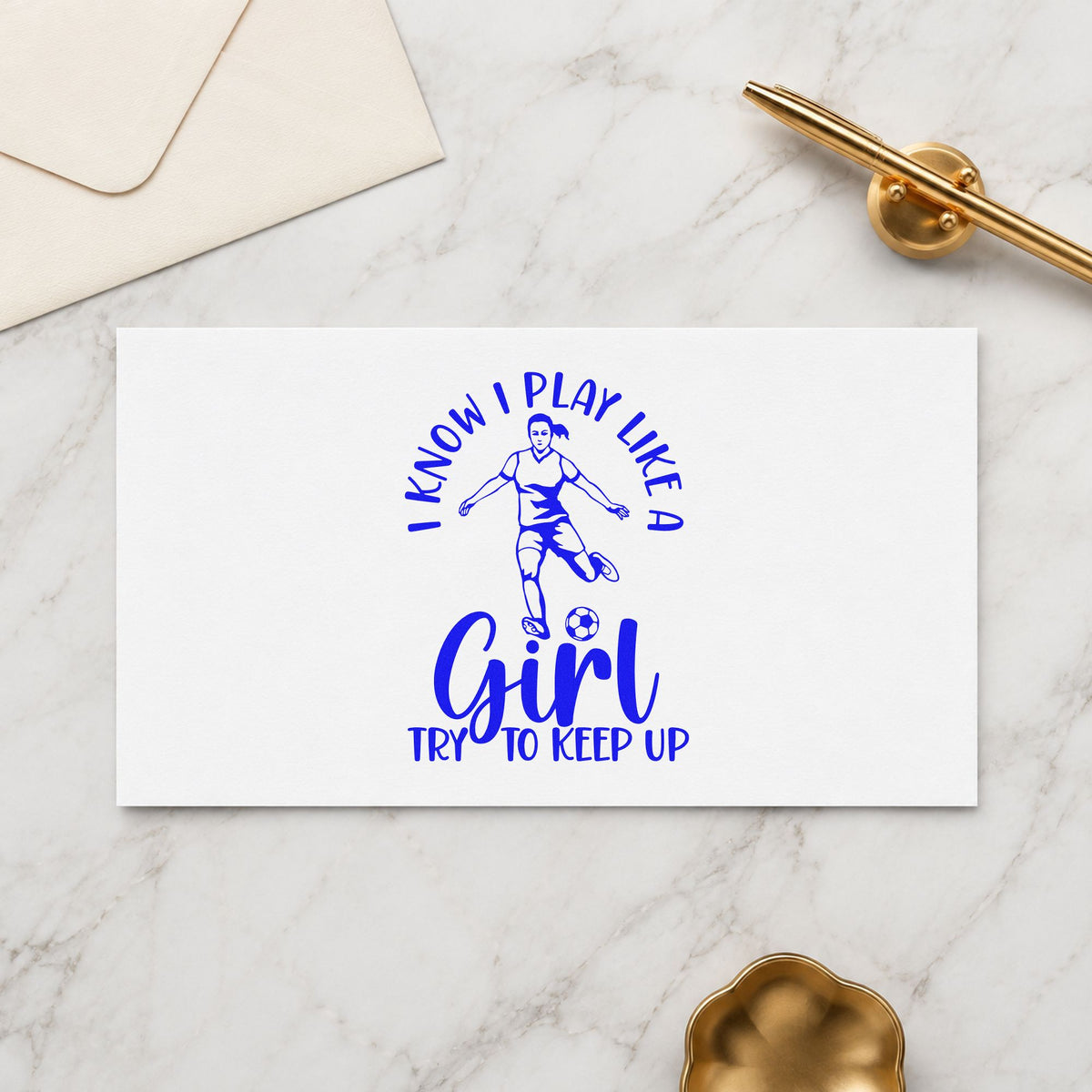 I Play Like a Girl craft stamp in blue ink on cardstock, an easy option for warmup shirt backs.