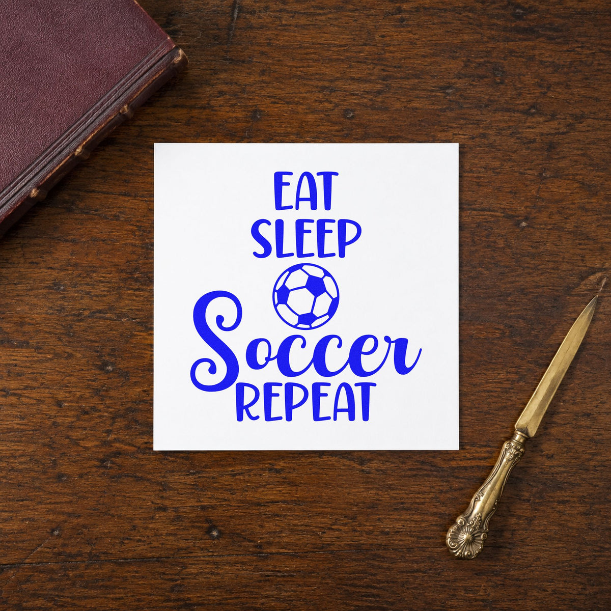 Eat Sleep Soccer Repeat craft stamp in blue ink on cardstock, an easy option for pajama set panels.