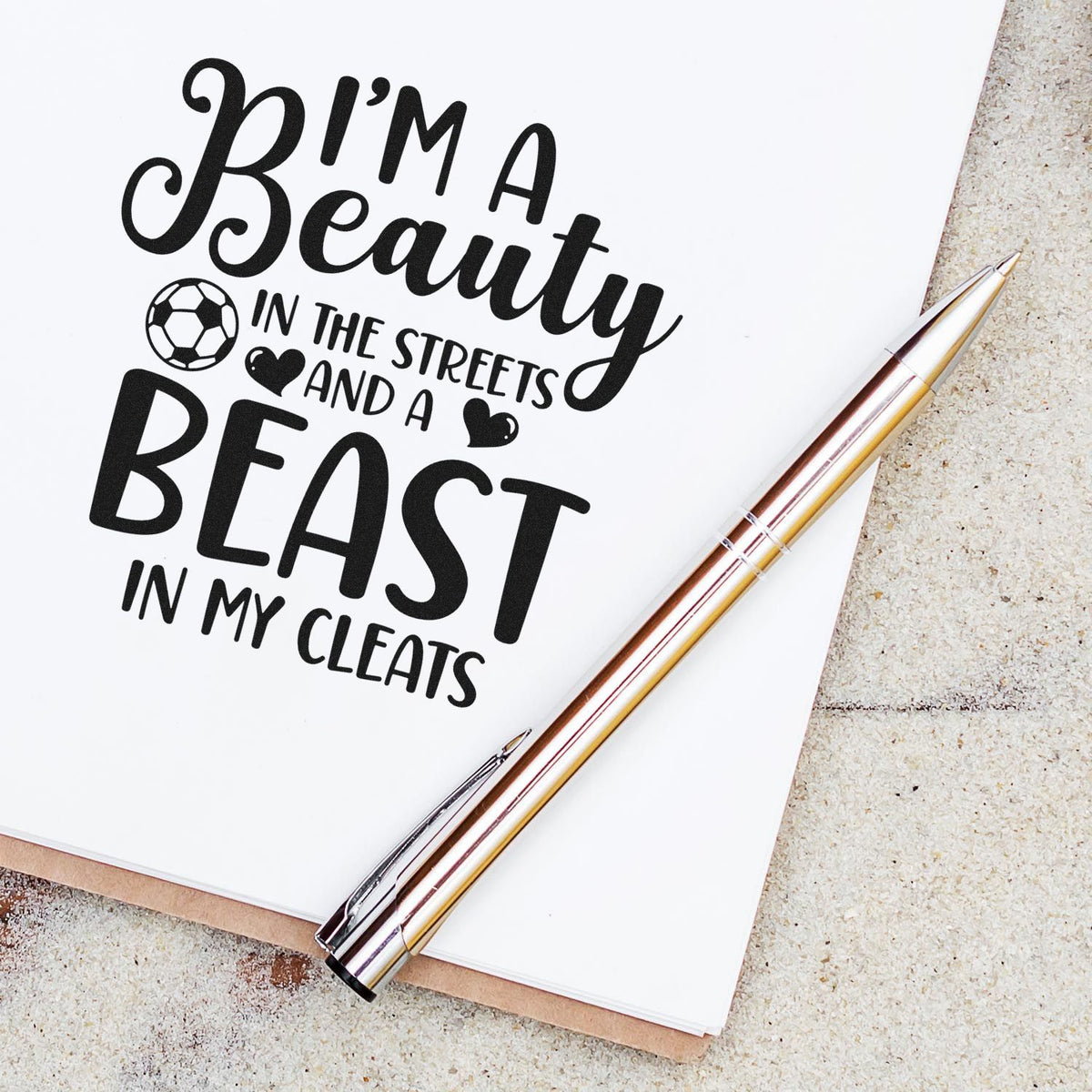 Black custom stamp and seal on white paper with soccer ball, hearts, and rose-gold pen; Im a Beauty BEAST in my cleats