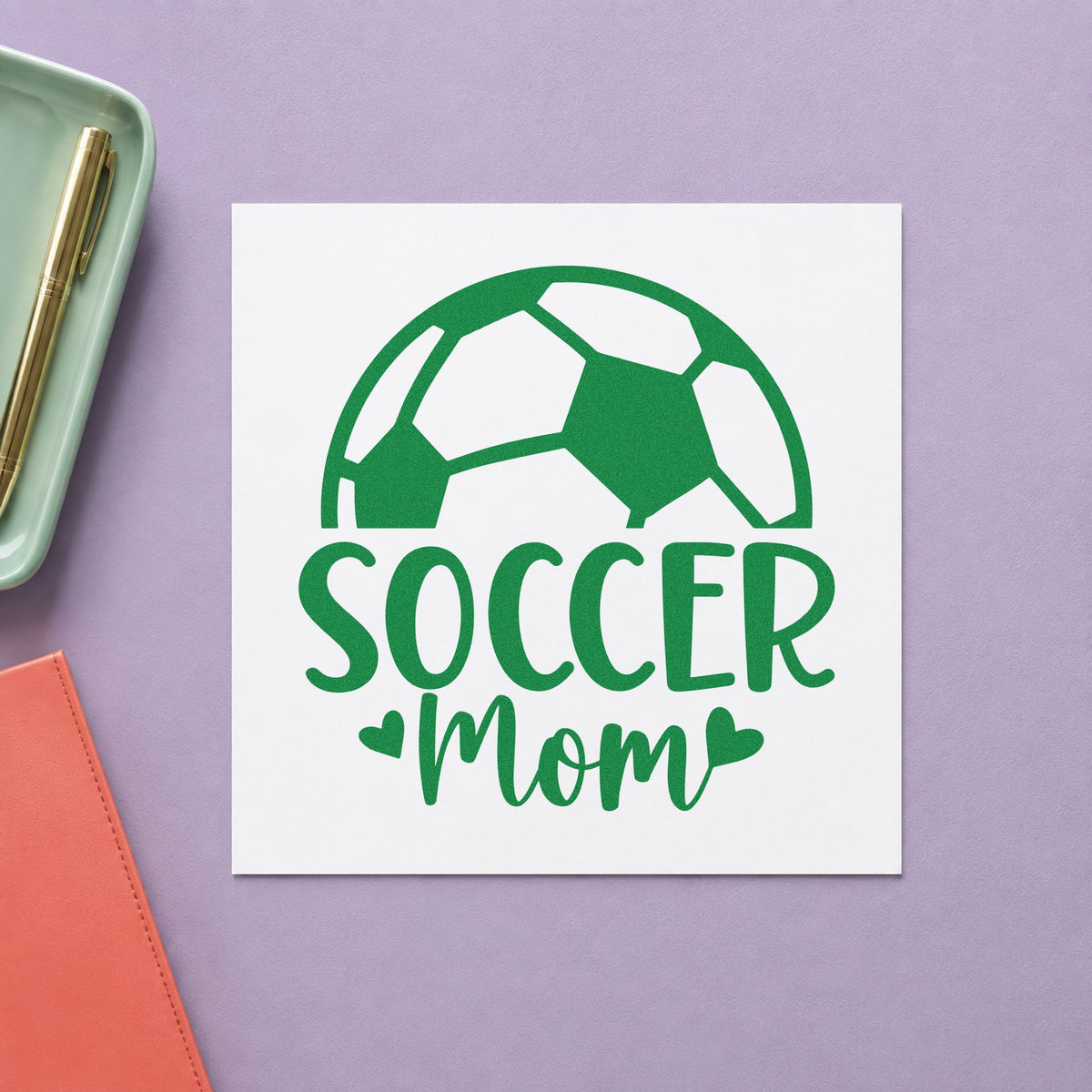 Soccer Mom Ball craft stamp imprint in green ink on a handmade project, one idea being carpool roster pages.