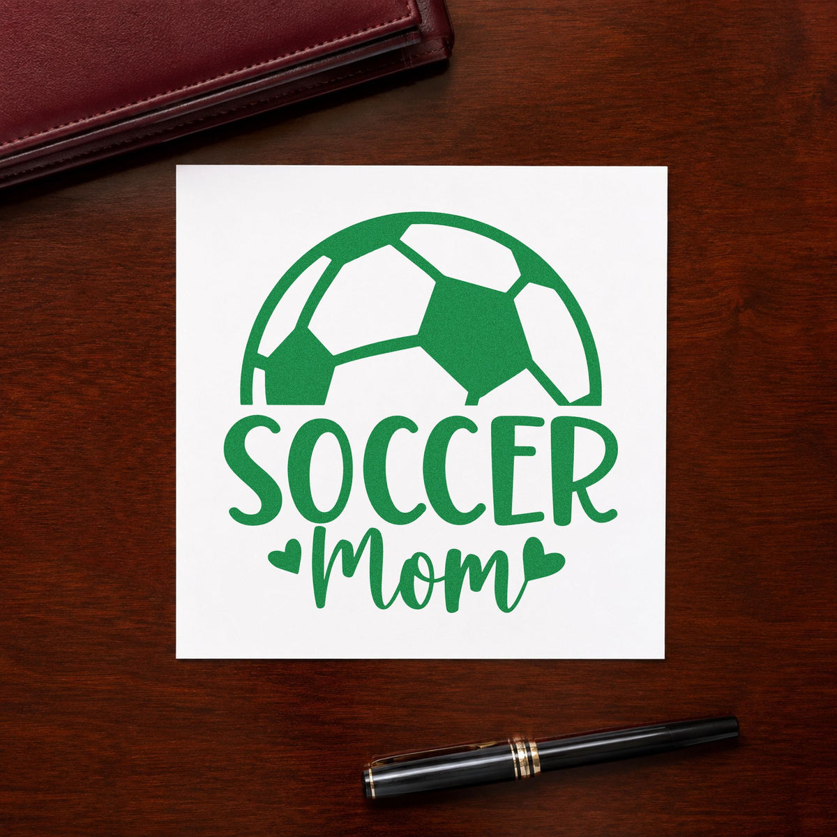 Soccer Mom Ball craft stamp imprint in green ink on a handmade project, one idea being framed mudroom wall.