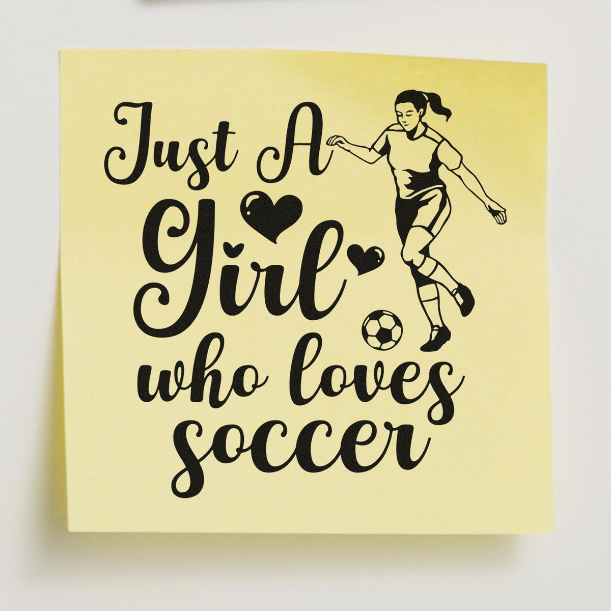 Yellow stamp design with black Just A Girl who loves soccer text, female player, hearts, and soccer ball.