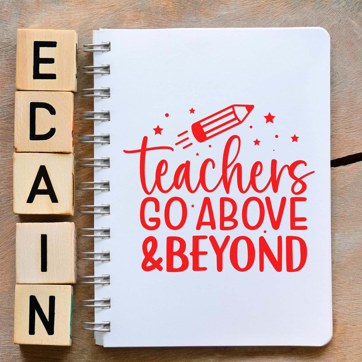 Wooden alphabet stamp blocks beside spiral notebook with red teacher appreciation stamp seal, pencil graphic, and stars.