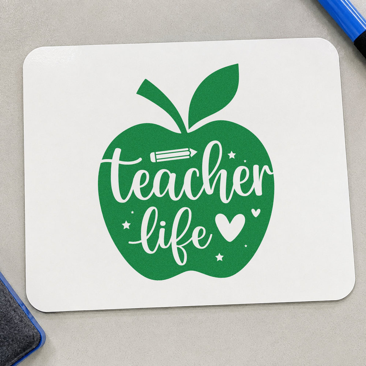 Teacher Life Apple craft stamp imprint in green ink on a handmade project, one idea being grade book pages.
