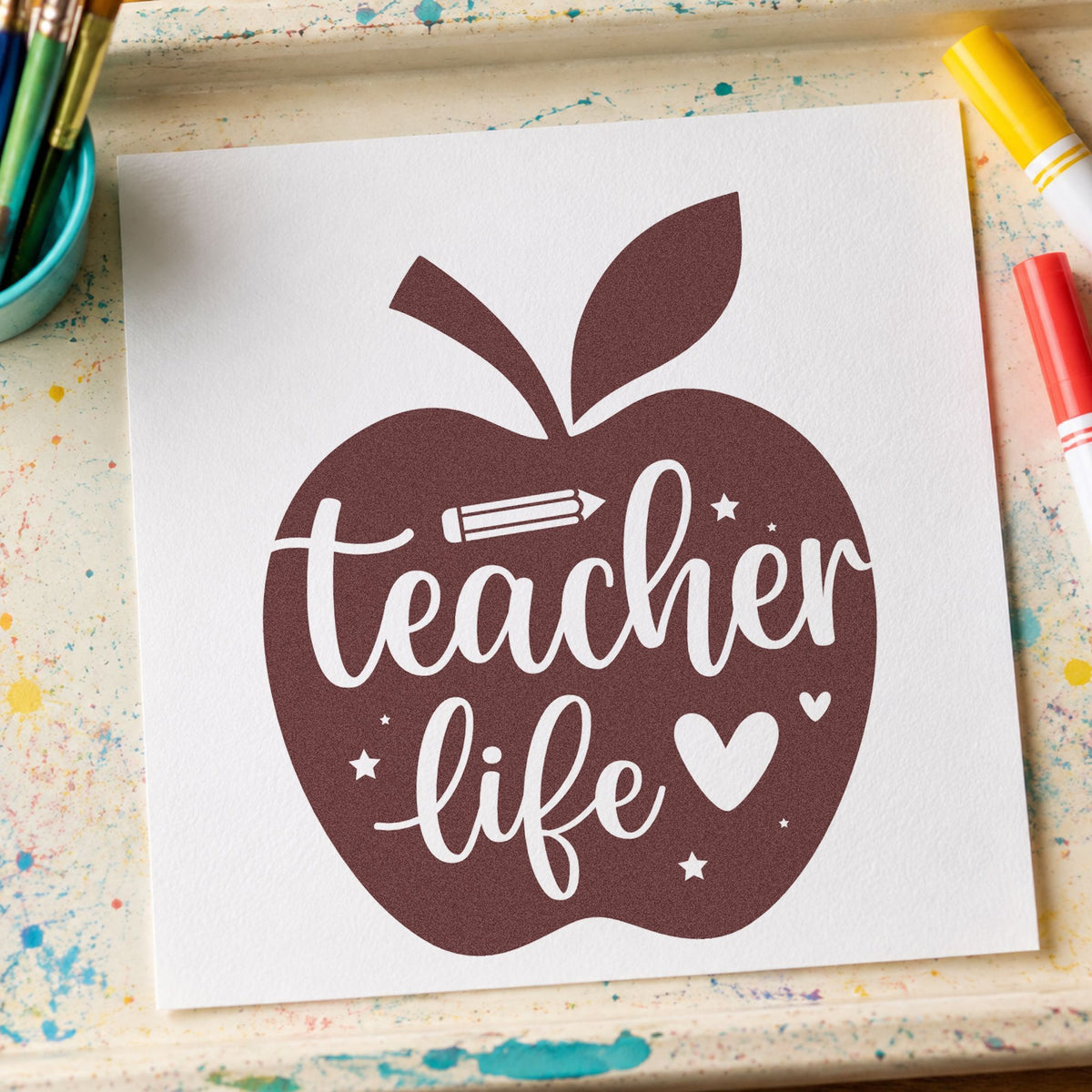 Teacher Life Apple rubber stamp printed in brown ink, ready for reward sticker sheets and similar paper crafts.