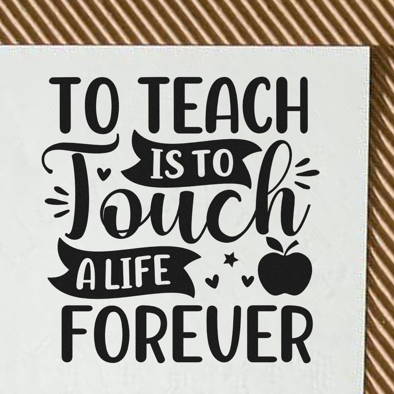 Black teacher stamp/seal design on white background with apple and hearts, reading To Teach Is To Touch A Life Forever.