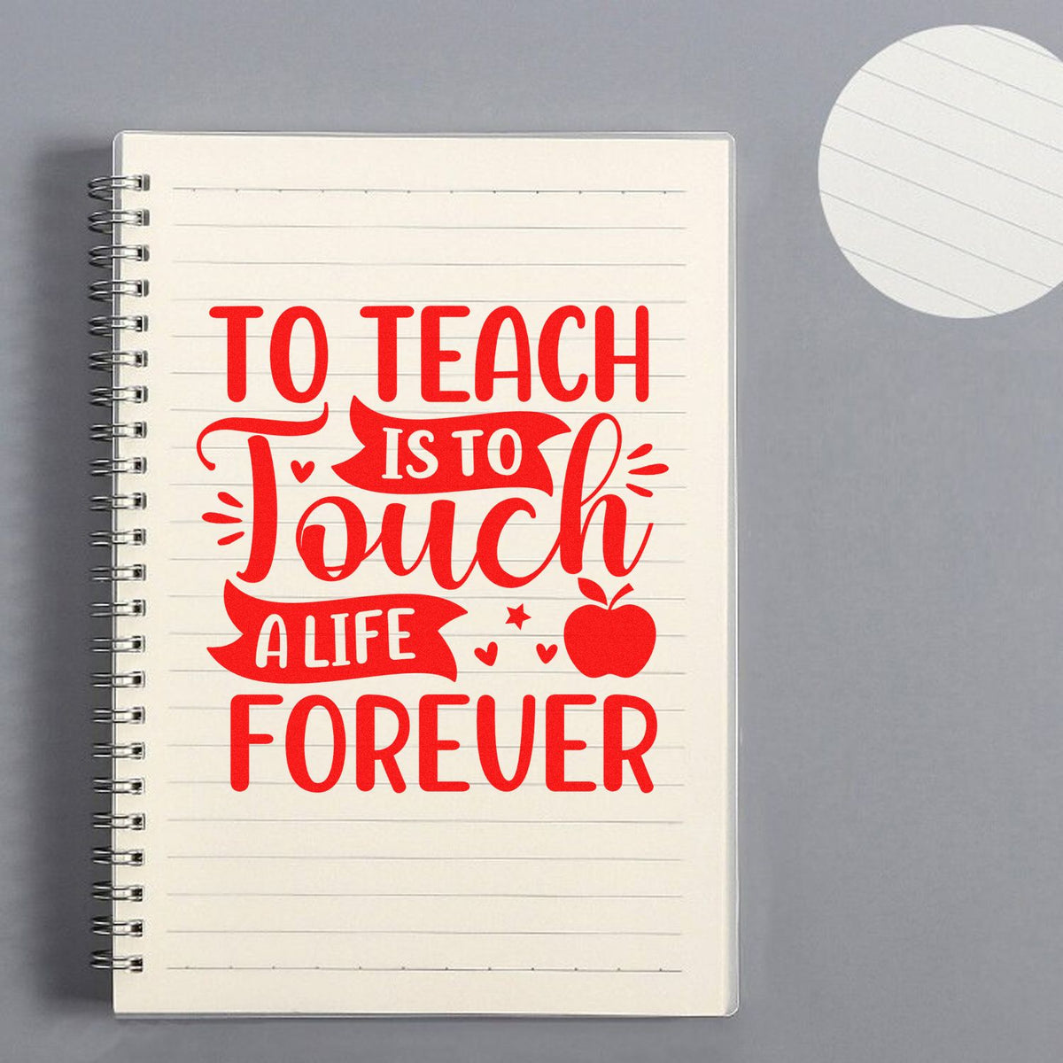 Red teacher quote stamp on cream lined spiral notebook, seal-style design reading To Teach Is to Touch a Life Forever.