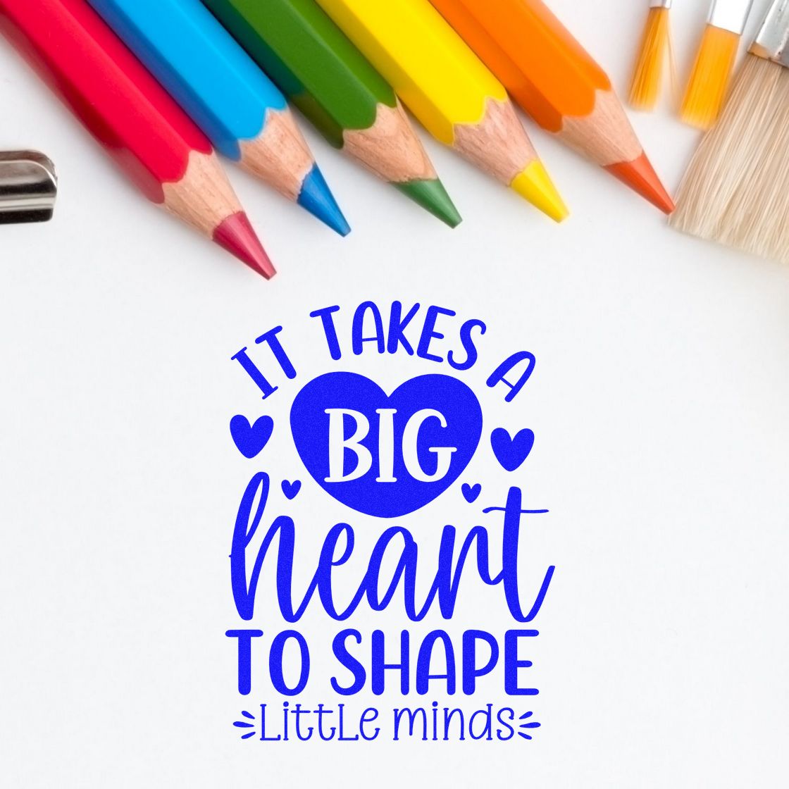 Blue heart stamp and seal design with slogan "It takes a big heart to shape little minds," bordered by colorful pencils.
