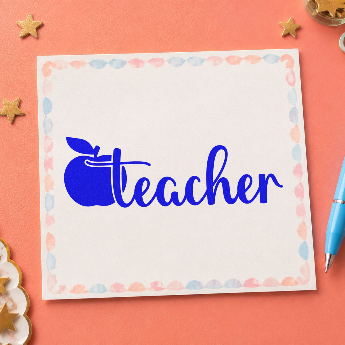 Teacher Apple Script craft stamp imprinted in blue ink on paper, a design suited to classroom door labels.