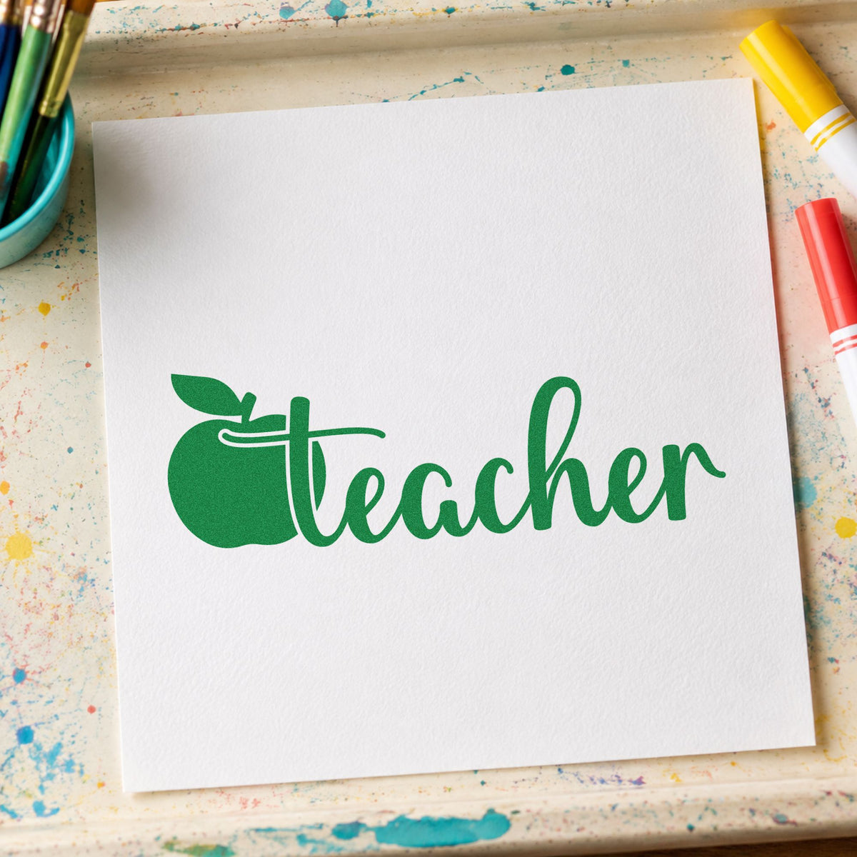 Teacher Apple Script craft stamp imprint in green ink on a handmade project, one idea being framed desk plaque.
