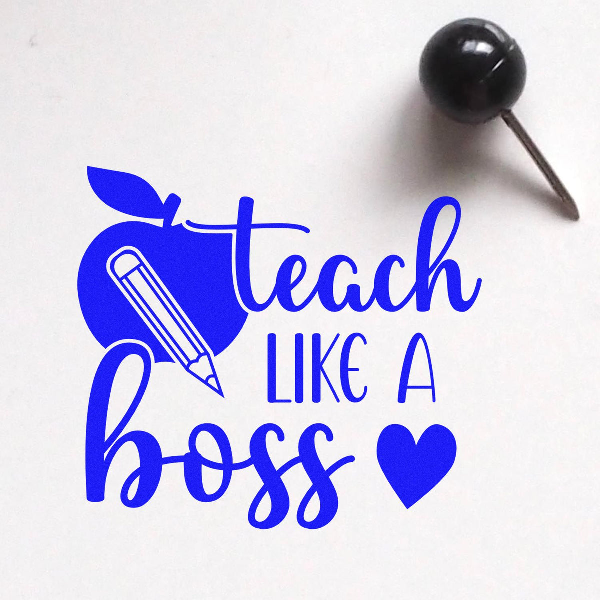 Blue custom stamp seal reading Teach Like a Boss with pencil icon, heart, and black pin tool.