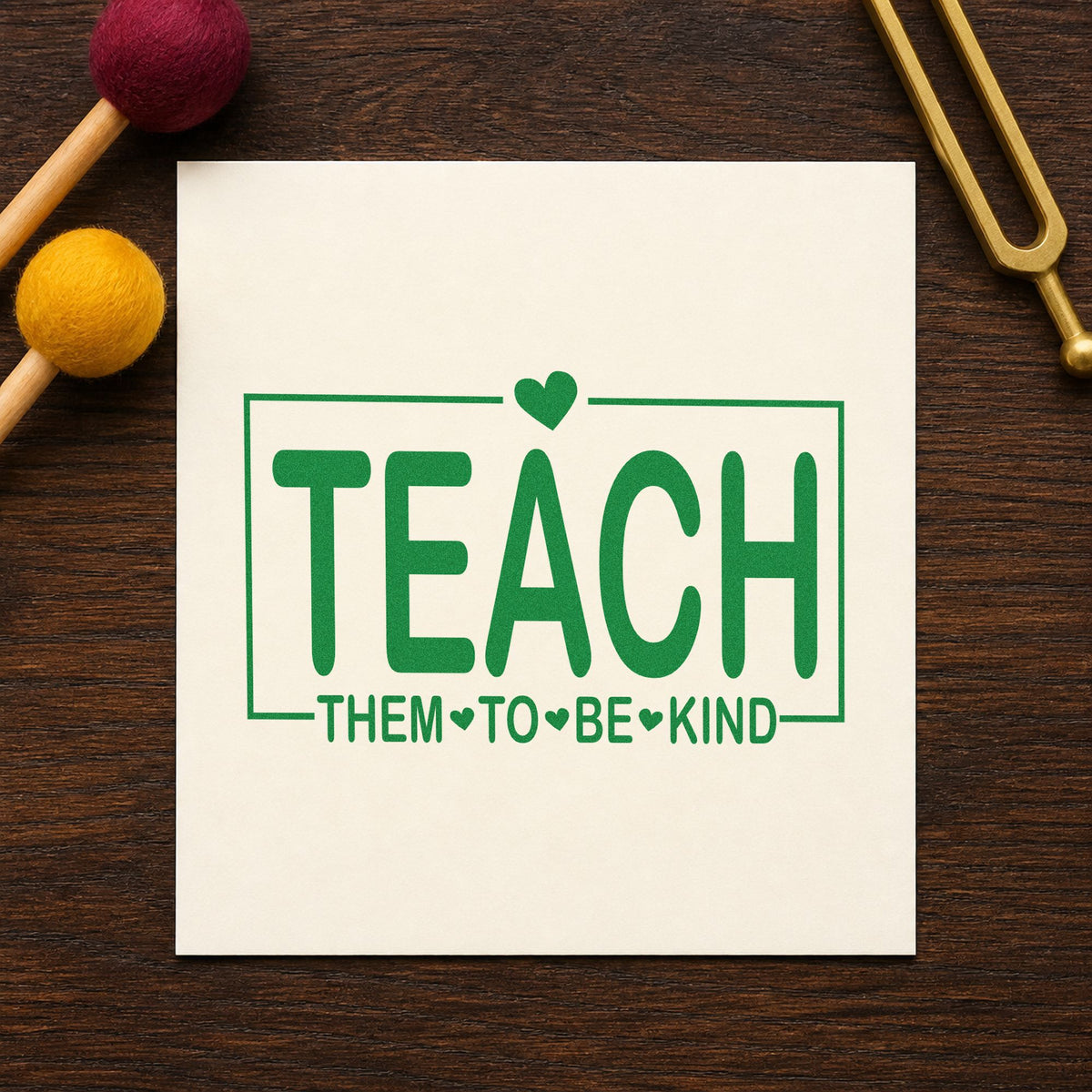 Teach Them to Be Kind craft stamp imprint in green ink on a handmade project, one idea being chore chart pages.