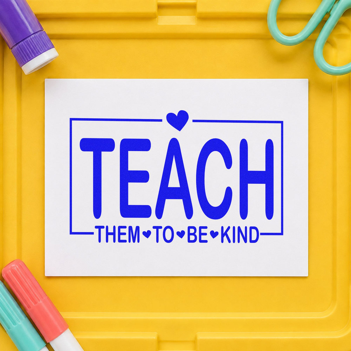 Teach Them to Be Kind craft stamp in blue ink on cardstock, an easy option for cousin camp tees.