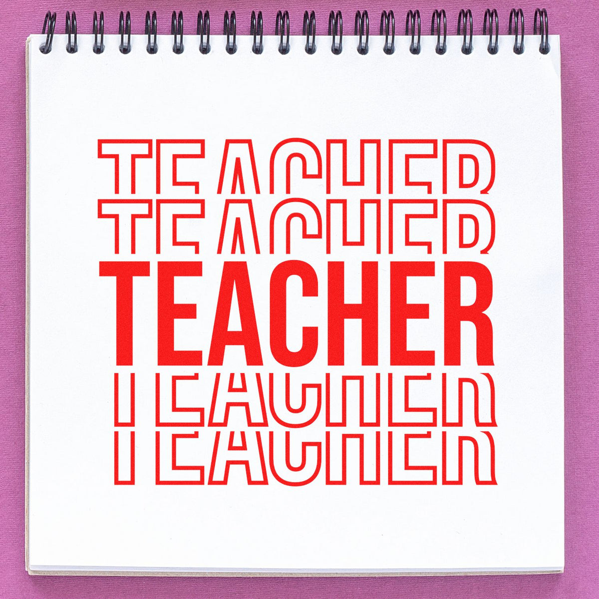 Red teacher stamp and seal text on a white spiral notebook, with bold layered lettering on a purple background.