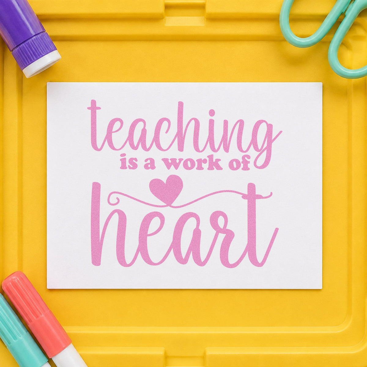 Teaching Is a Work of Heart craft stamp in purple ink on cardstock, an easy option for tribute book tags.