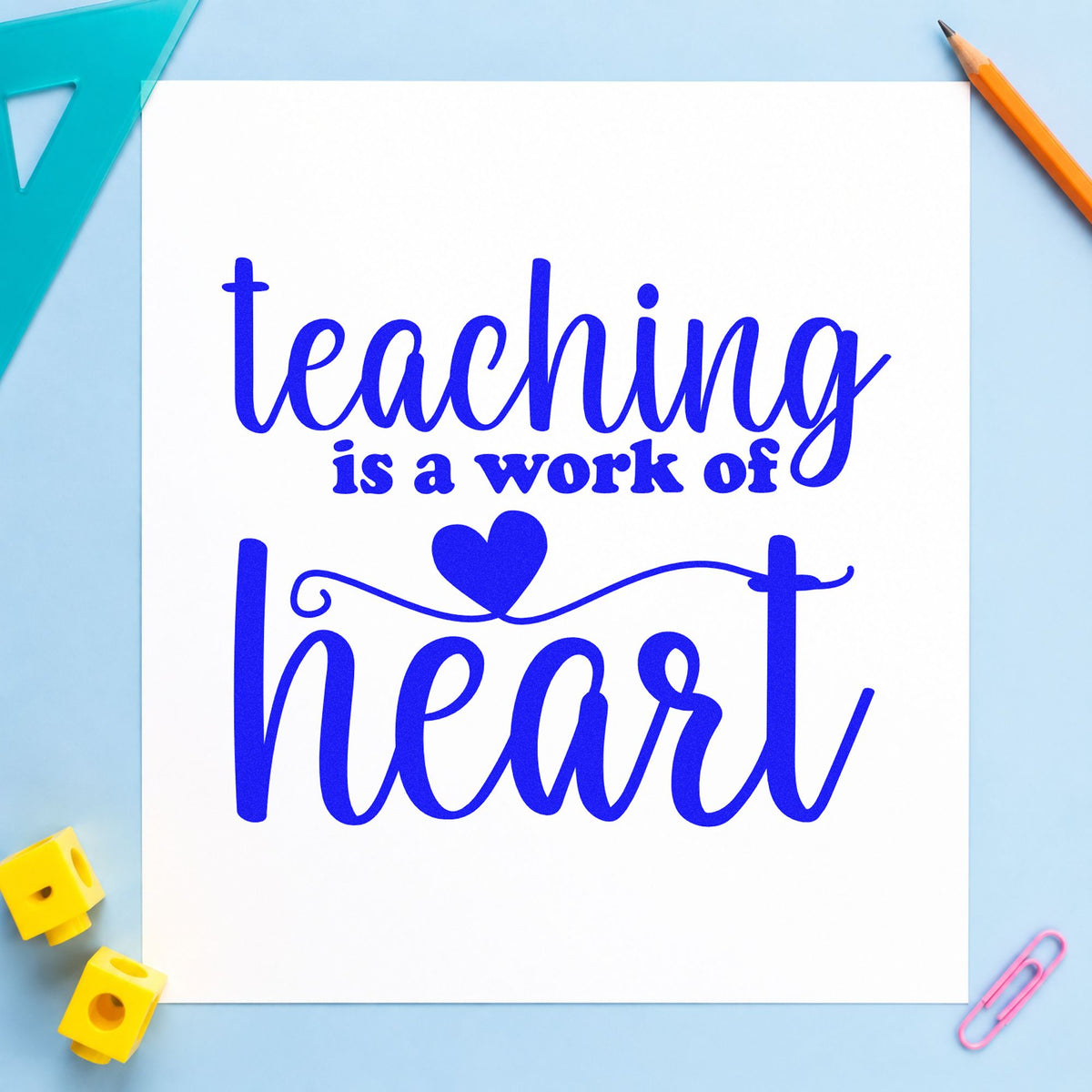 Teaching Is a Work of Heart craft stamp in blue ink on cardstock, an easy option for quilt center panels.