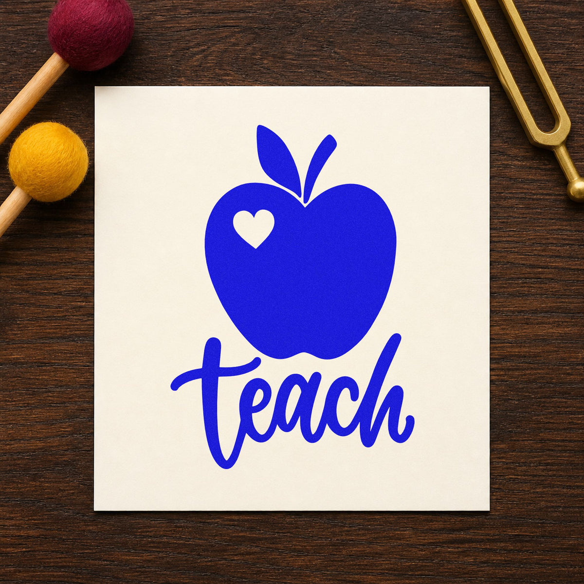 Teach Apple Heart craft stamp in blue ink on cardstock, an easy option for muslin bag panels.