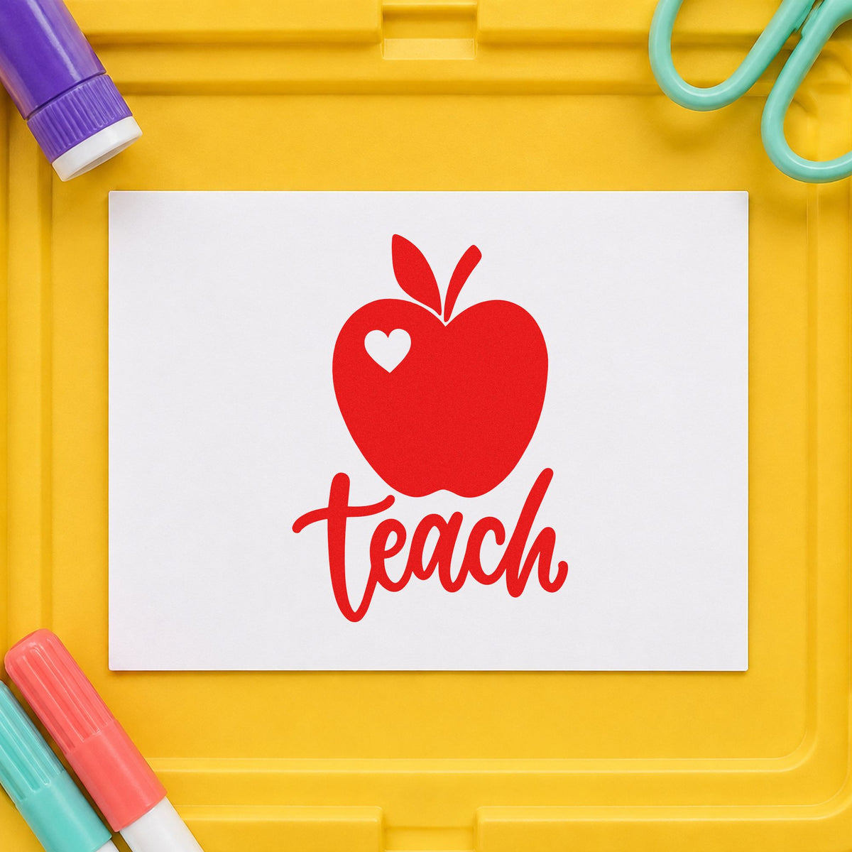 Teach Apple Heart rubber stamp shown in red ink, stamped for projects such as new room notes.
