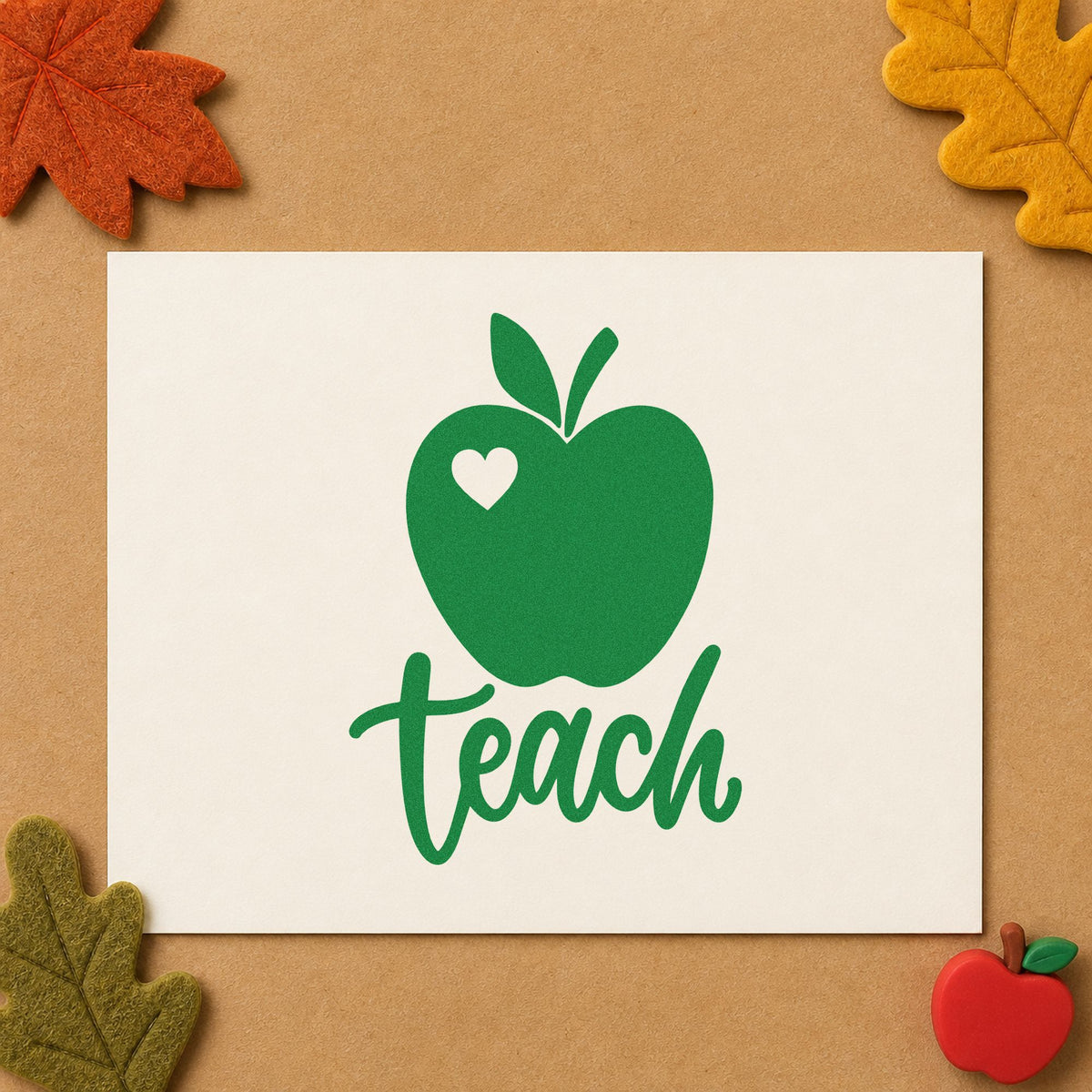 Teach Apple Heart craft stamp imprint in green ink on a handmade project, one idea being framed small print.