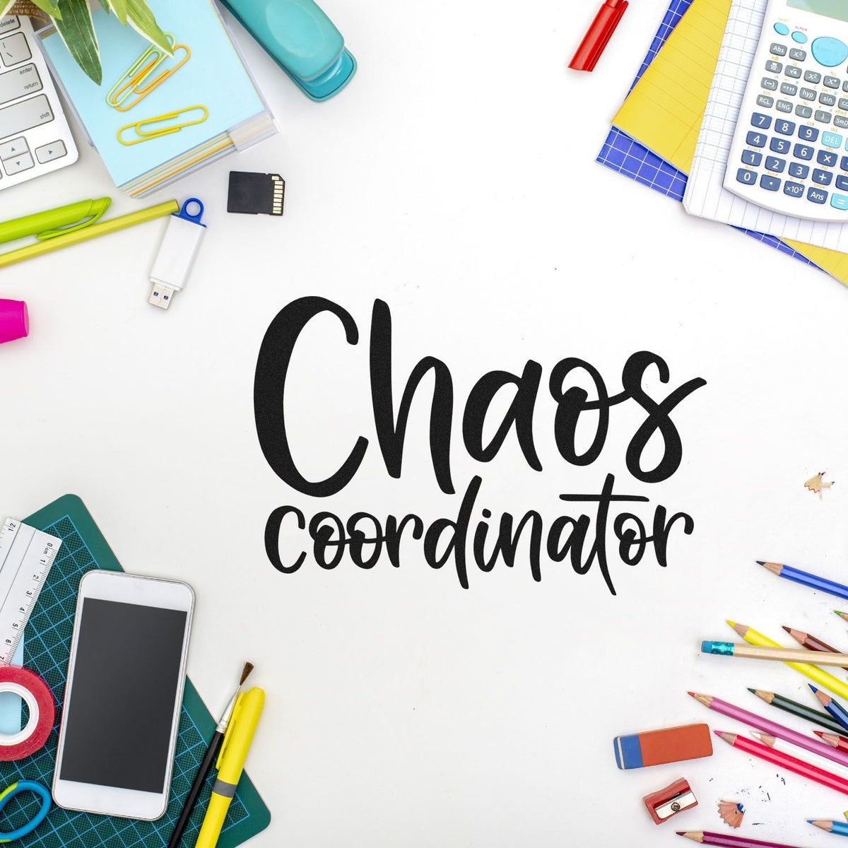 Black Chaos Coordinator stamp and seal on white, framed by colorful stationery, calculator, phone, and office supplies.