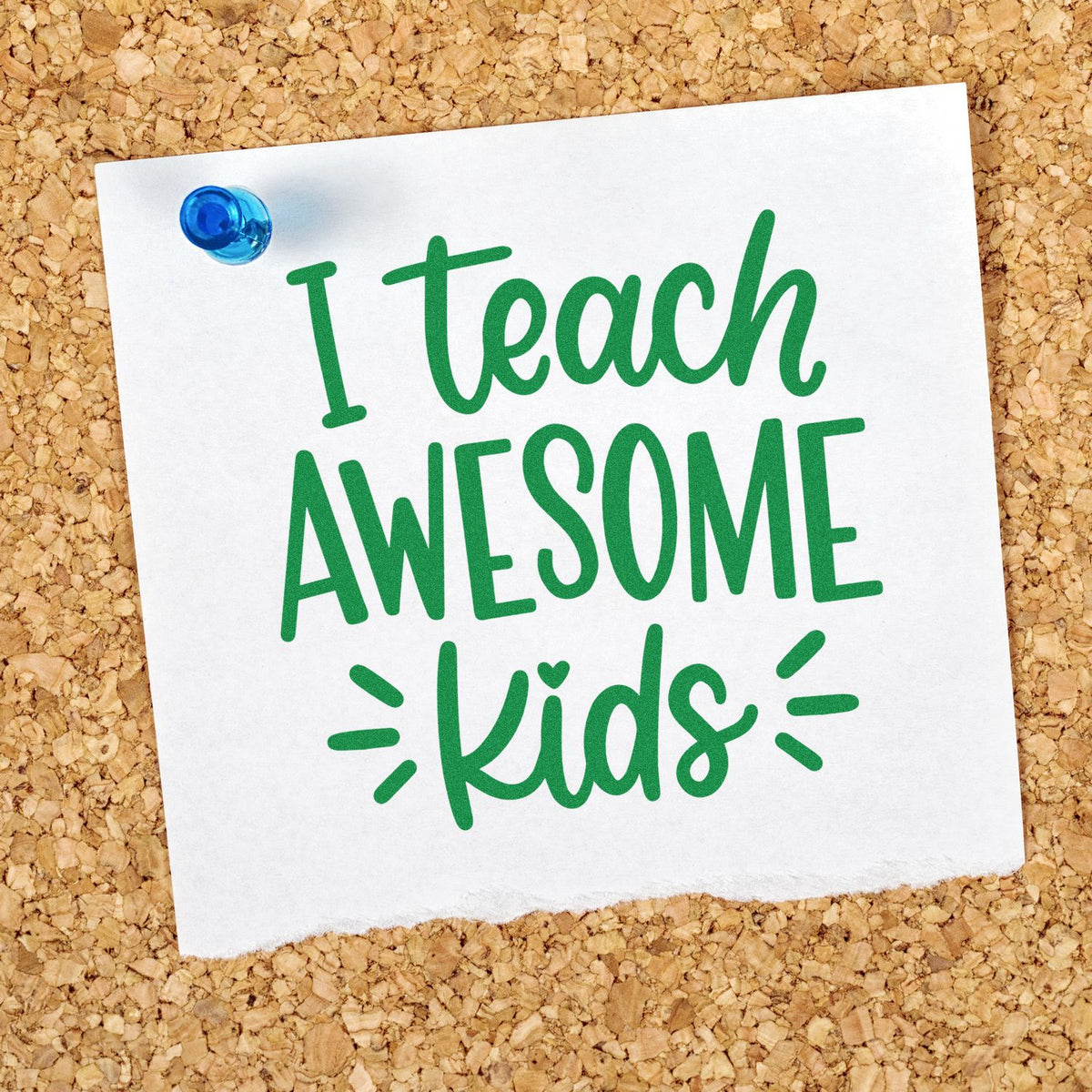 Green I teach AWESOME kids stamp seal on white paper, pinned with a blue tack on a corkboard.