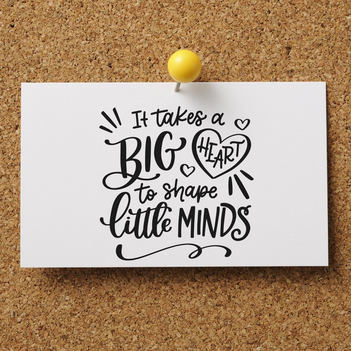 Black stamp and seal quote on a white card, pinned with a yellow tack, against a tan corkboard.