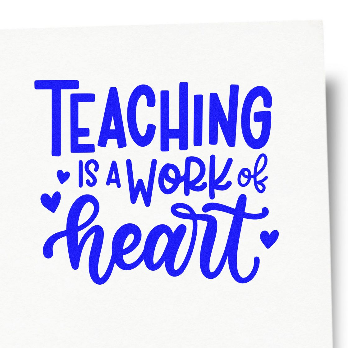 Teaching Work of Heart rubber stamp shown in blue ink, stamped for projects such as buddy class tags.