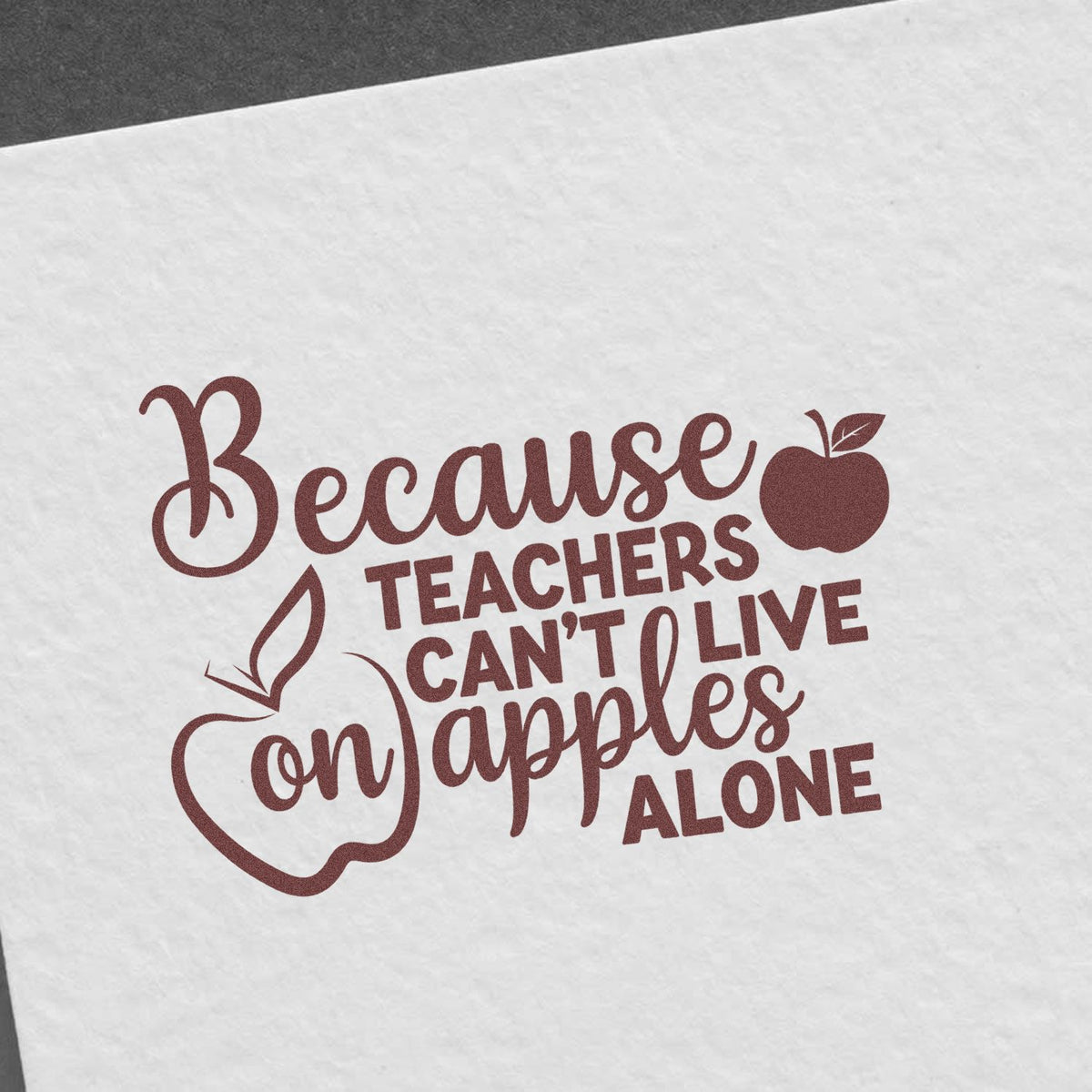 Maroon teacher stamp seal on white paper with apple icons and text, Because teachers cant live on apples alone.