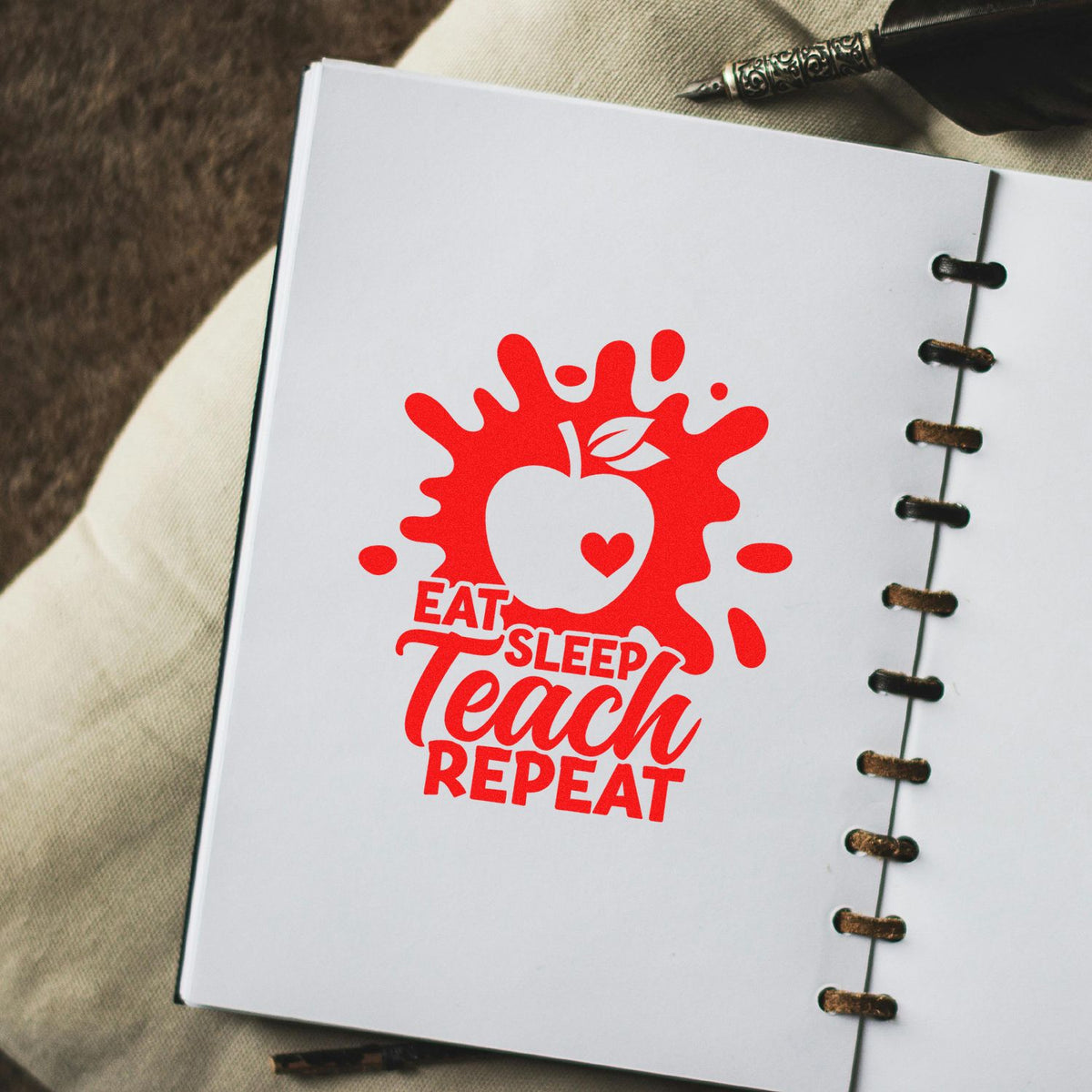 Red teacher stamp seal on white notebook page with apple icon and Eat Sleep Teach Repeat text.