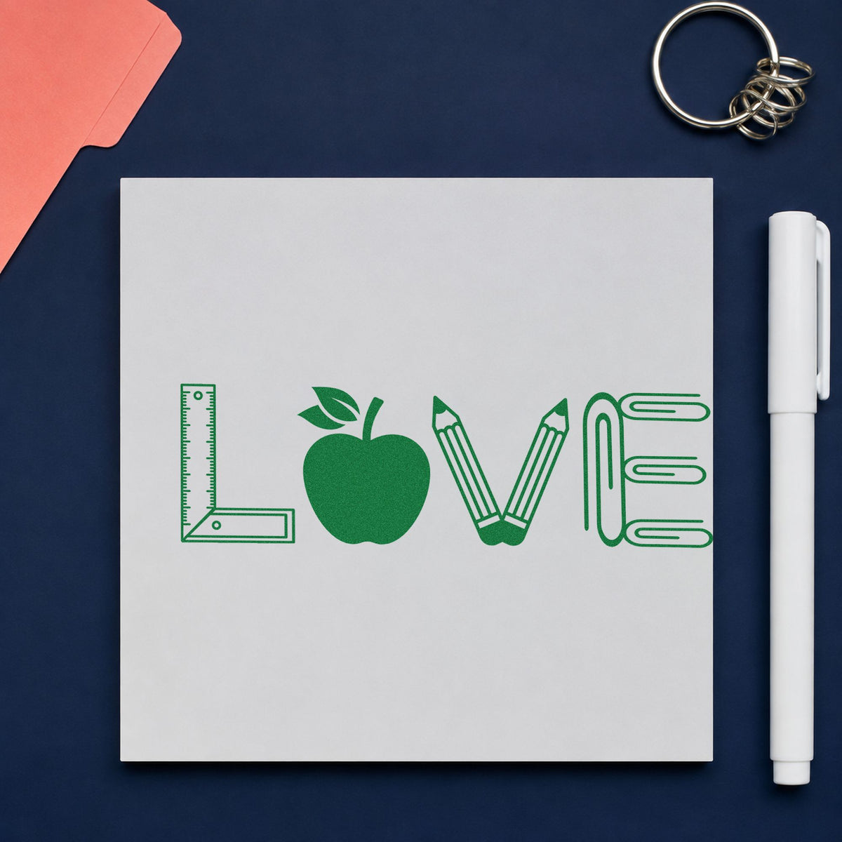 Love School Supplies craft stamp imprint in green ink on a handmade project, one idea being framed shelf wall.