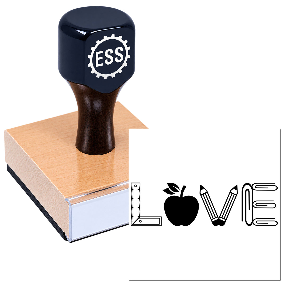 Black ESS stamp seal on a wooden base with white school icons: ruler, apple, pencils, and paperclip.