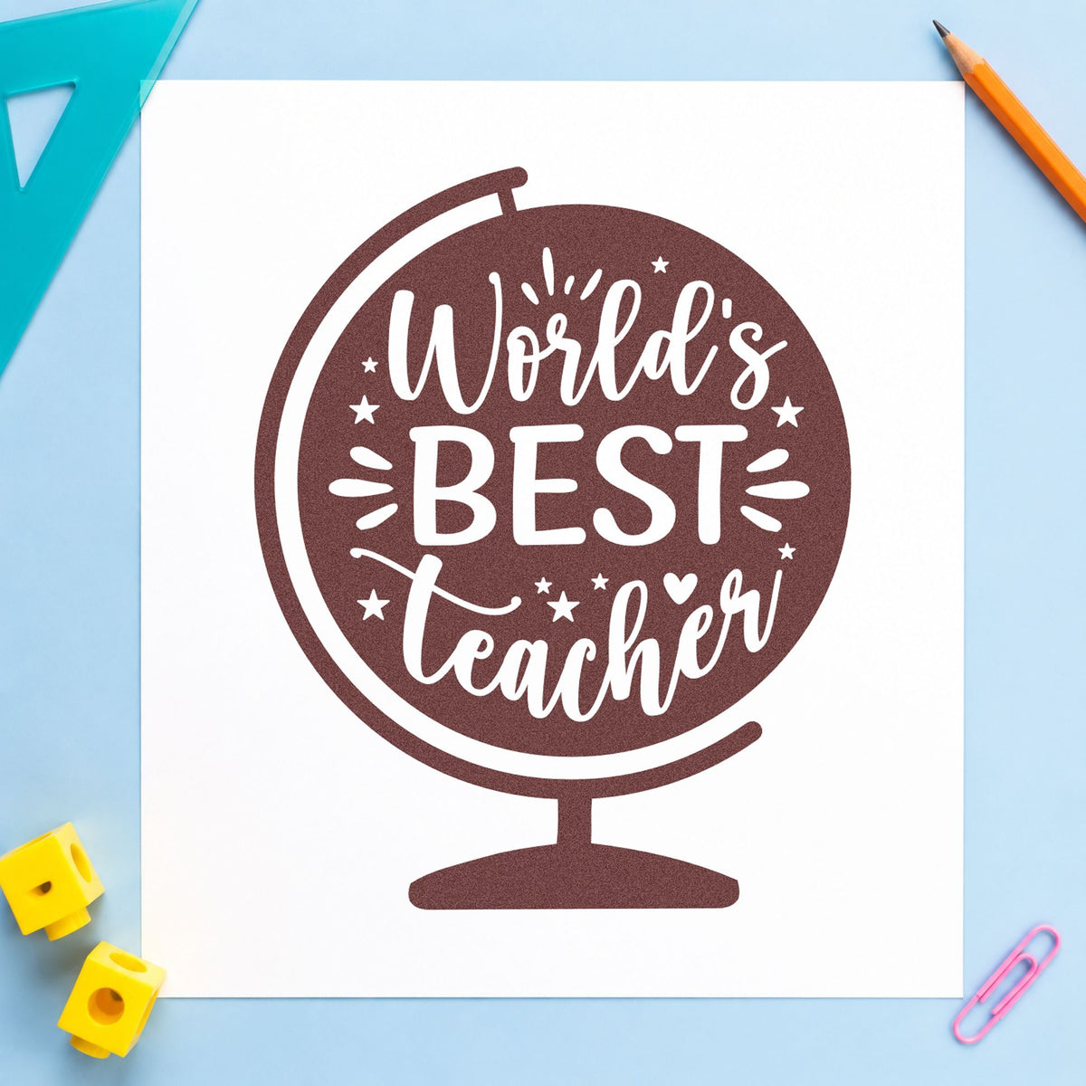 World's Best Teacher Globe rubber stamp printed in brown ink, ready for paperweight crafts and similar paper crafts.
