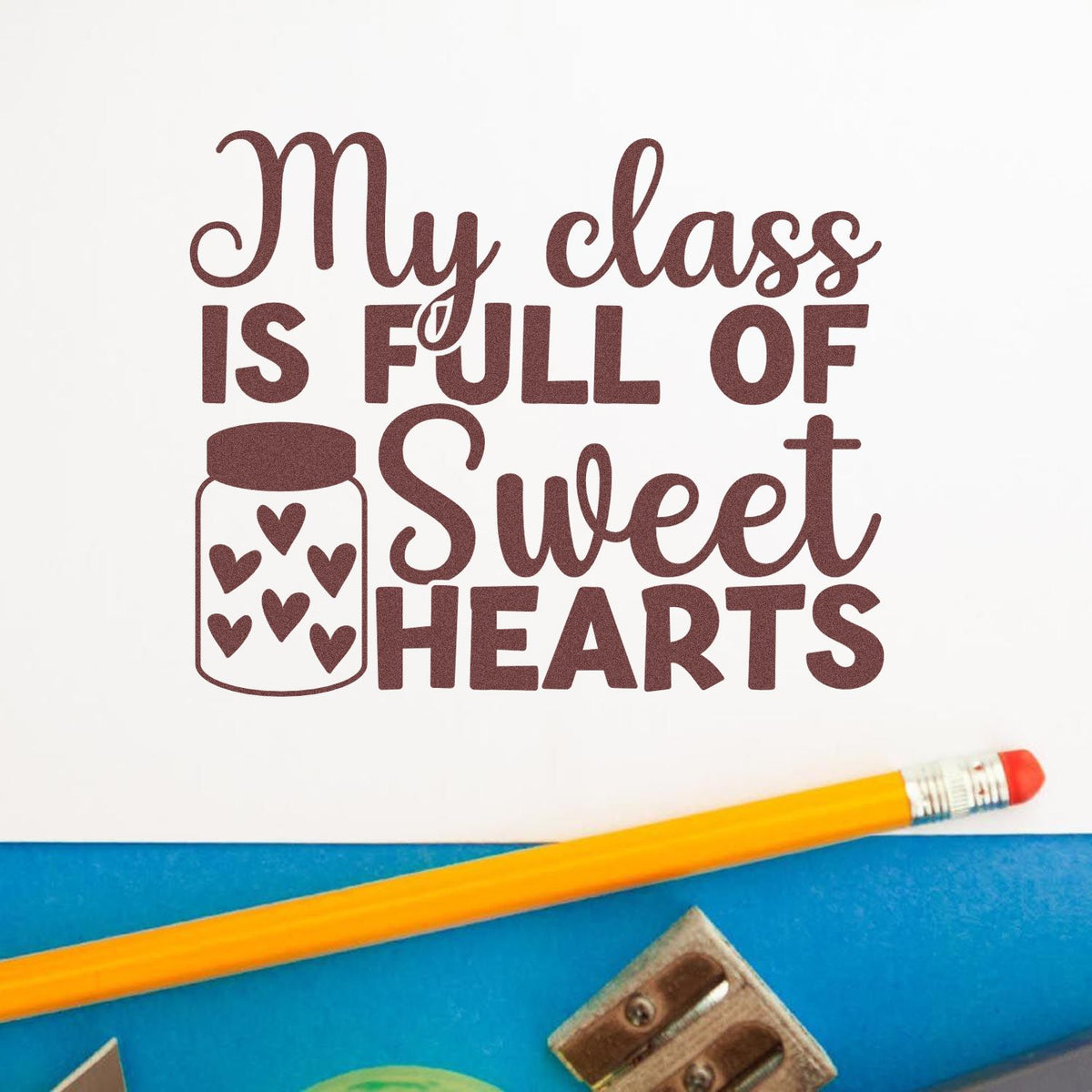 Brown stamp and seal design reading "My class is full of sweet hearts" with heart jar icon on white, beside a yellow pencil.