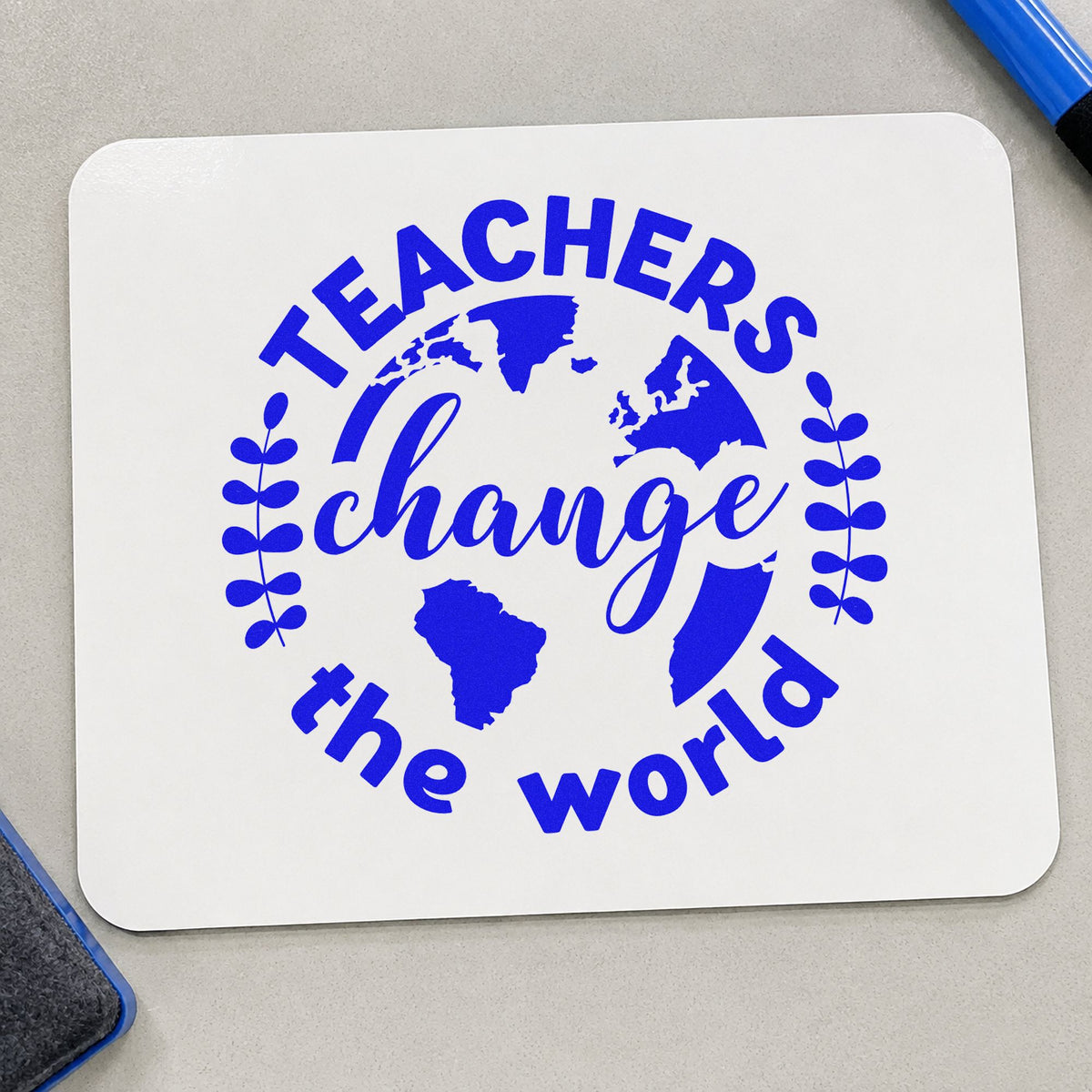 Teachers Change World Globe craft stamp imprinted in blue ink on paper, a design suited to earth day seals.