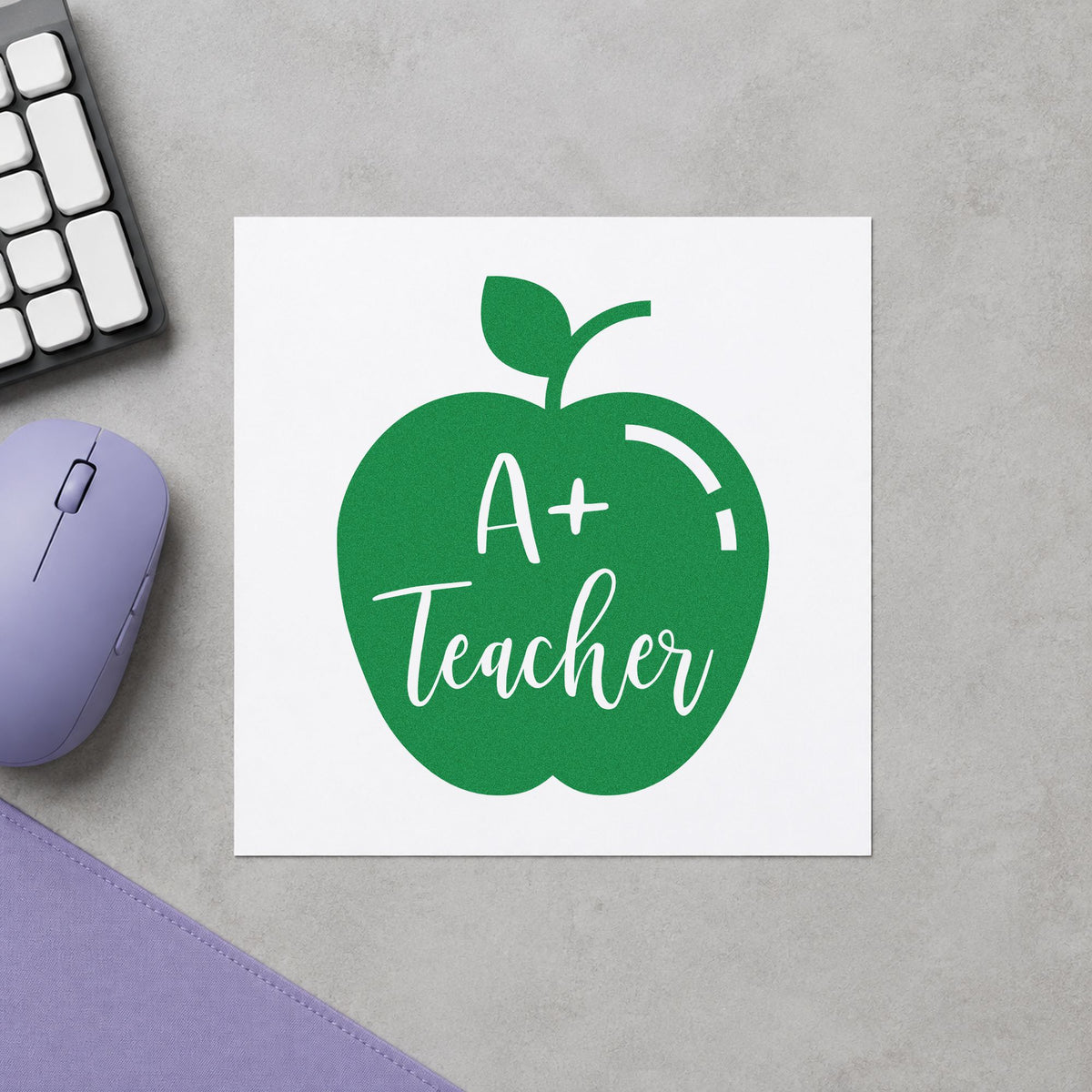 A Plus Teacher Solid Apple craft stamp imprint in green ink on a handmade project, one idea being exam result pages.