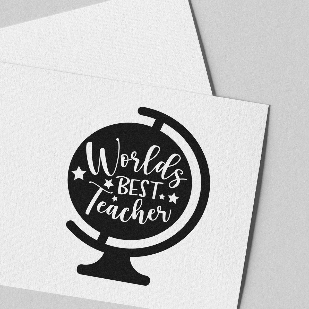 Black Worlds Best Teacher stamp seal on white textured paper, with globe icon and stars.
