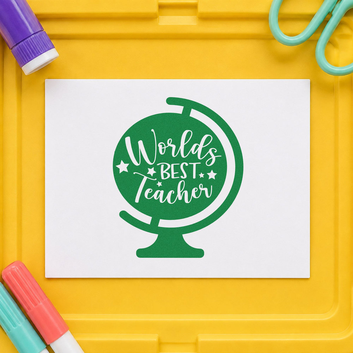 World's Best Teacher Tilted Globe craft stamp imprint in green ink on a handmade project, one idea being nomination form pages.