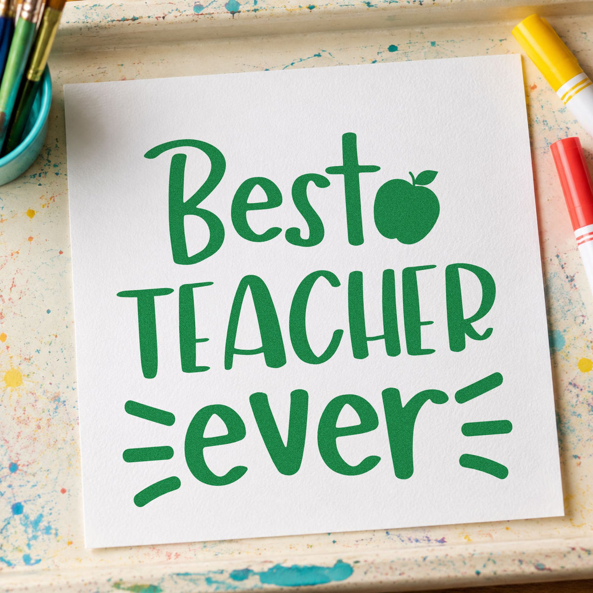 Best Teacher Ever craft stamp imprint in green ink on a handmade project, one idea being framed desk tile.