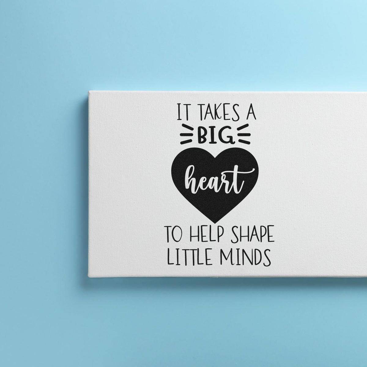 Custom black stamp and seal design with heart quote on white canvas against a light blue background.