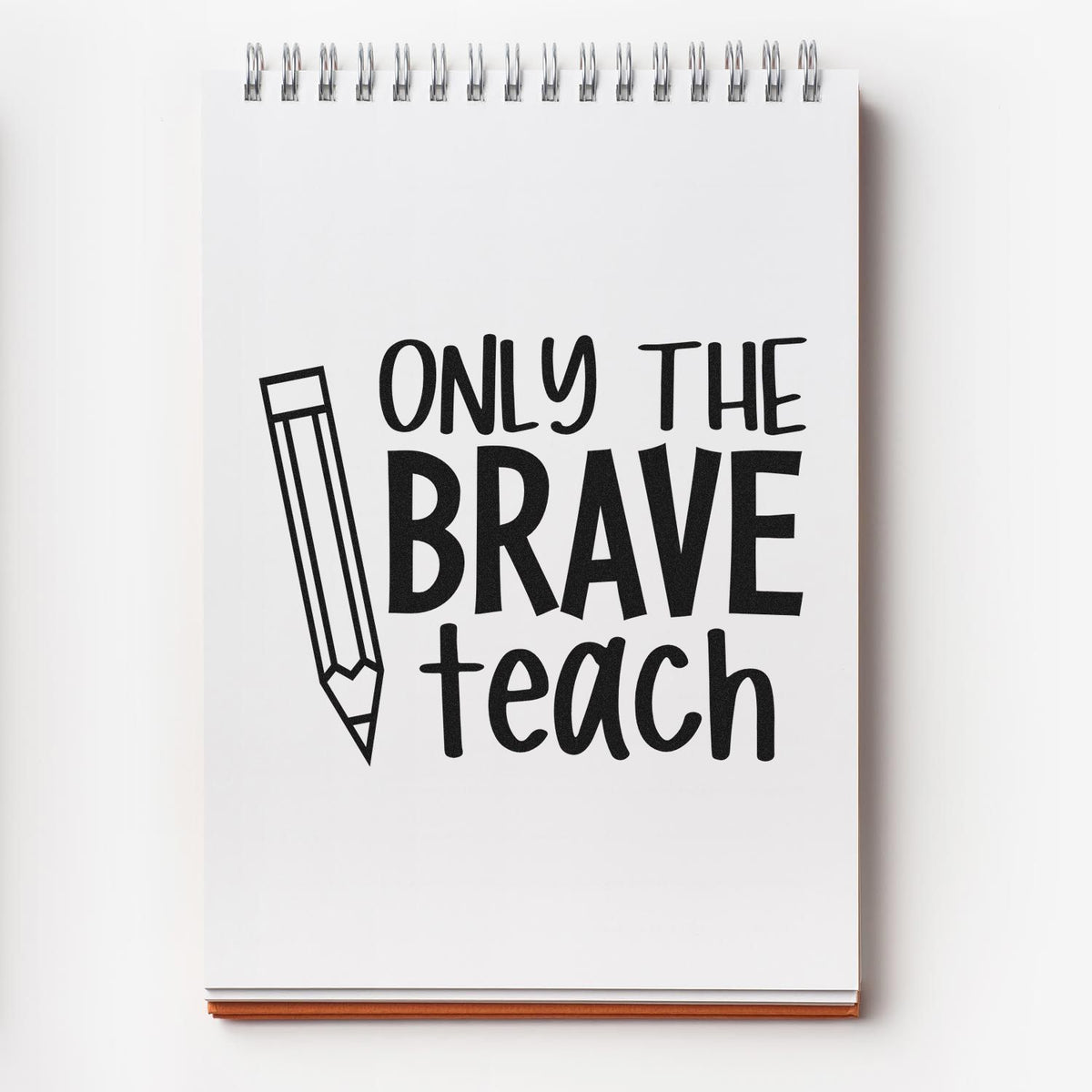 Black stamp/seal design on a white spiral notebook with a pencil icon and bold Only the Brave Teach text.