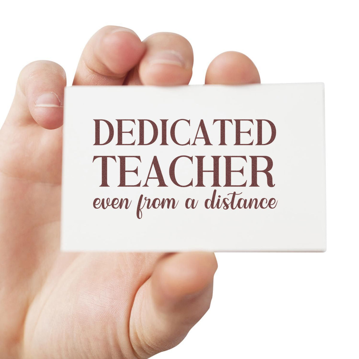 Handheld white stamp seal with maroon text, Dedicated Teacher even from a distance.