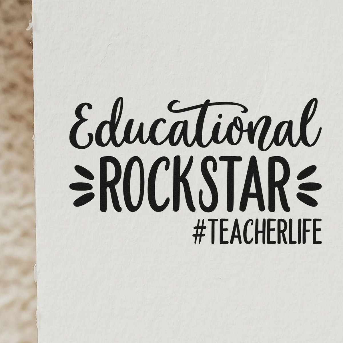 Black Educational ROCKSTAR #TEACHERLIFE stamp and seal design on white paper, bold teacher-life text.