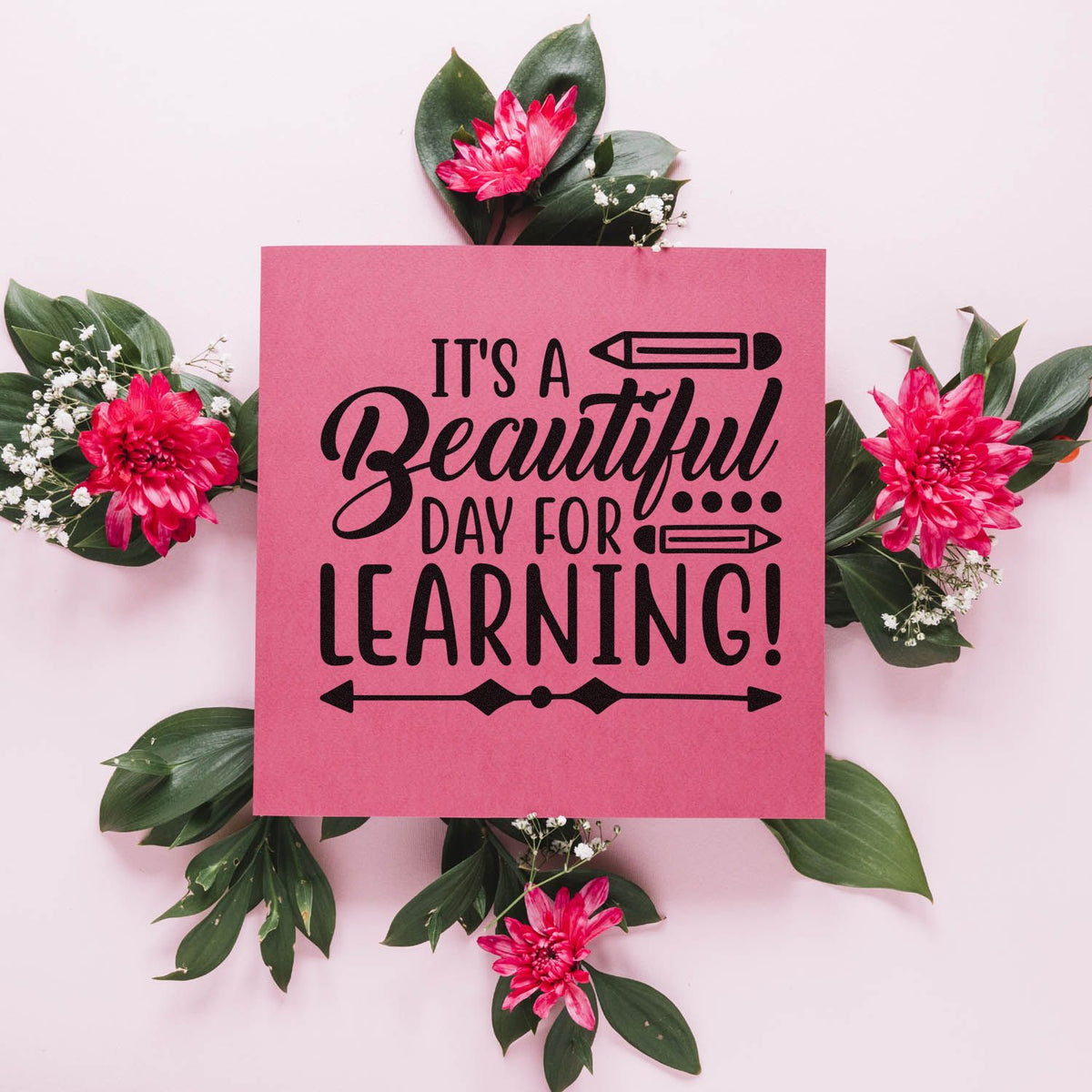 Pink stamp and seal with black Its a Beautiful Day for Learning! text, framed by green leaves and bright pink flowers.