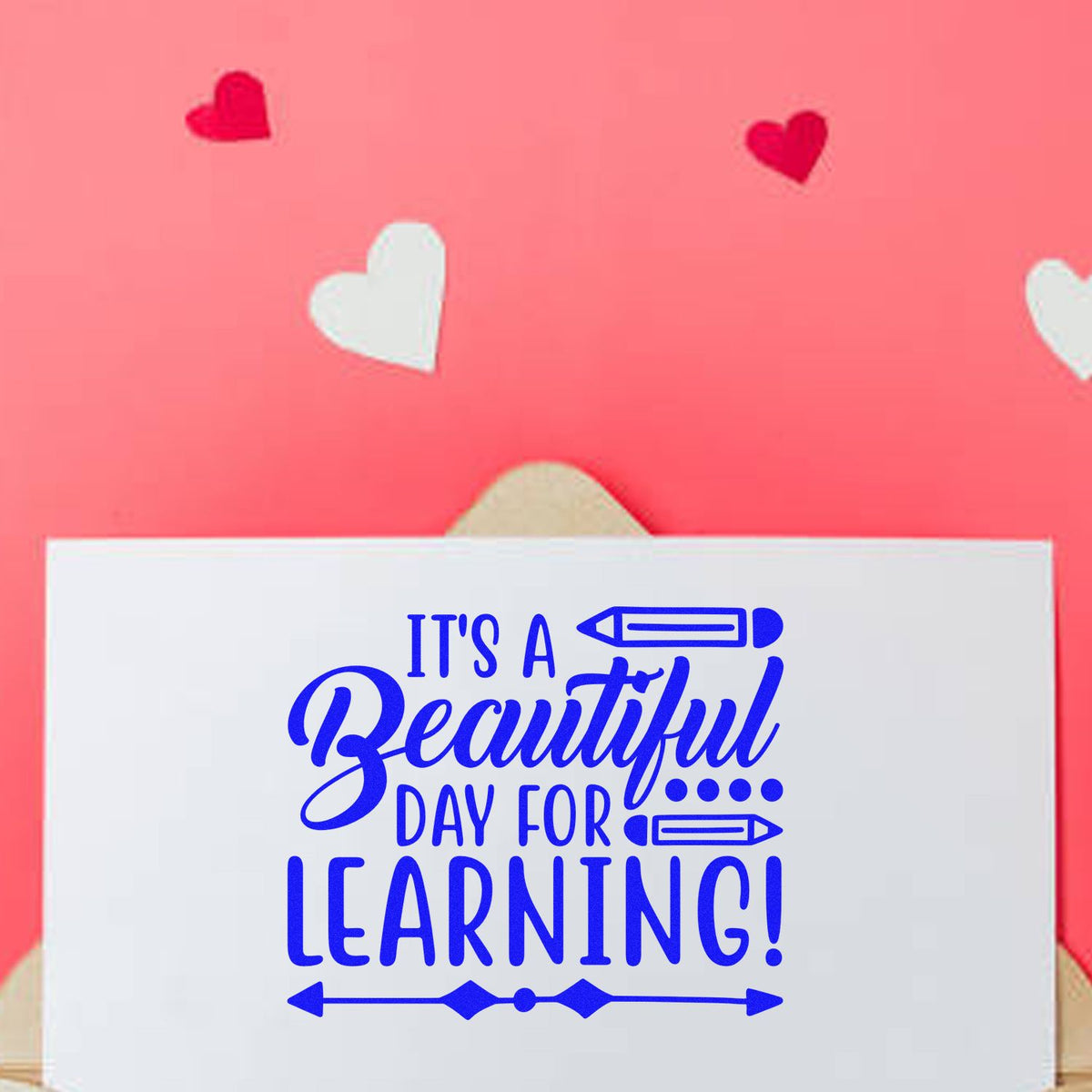Blue stamp-style seal reading Its a Beautiful Day for Learning! on a white card, with pink background and heart accents.