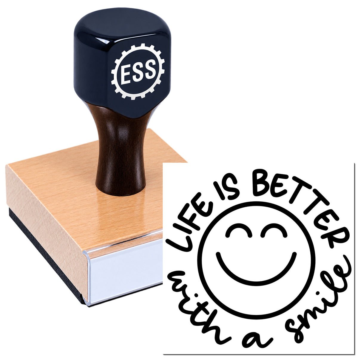 Dark navy ESS rubber stamp on wooden block beside black smiley seal reading "Life is better with a smile".
