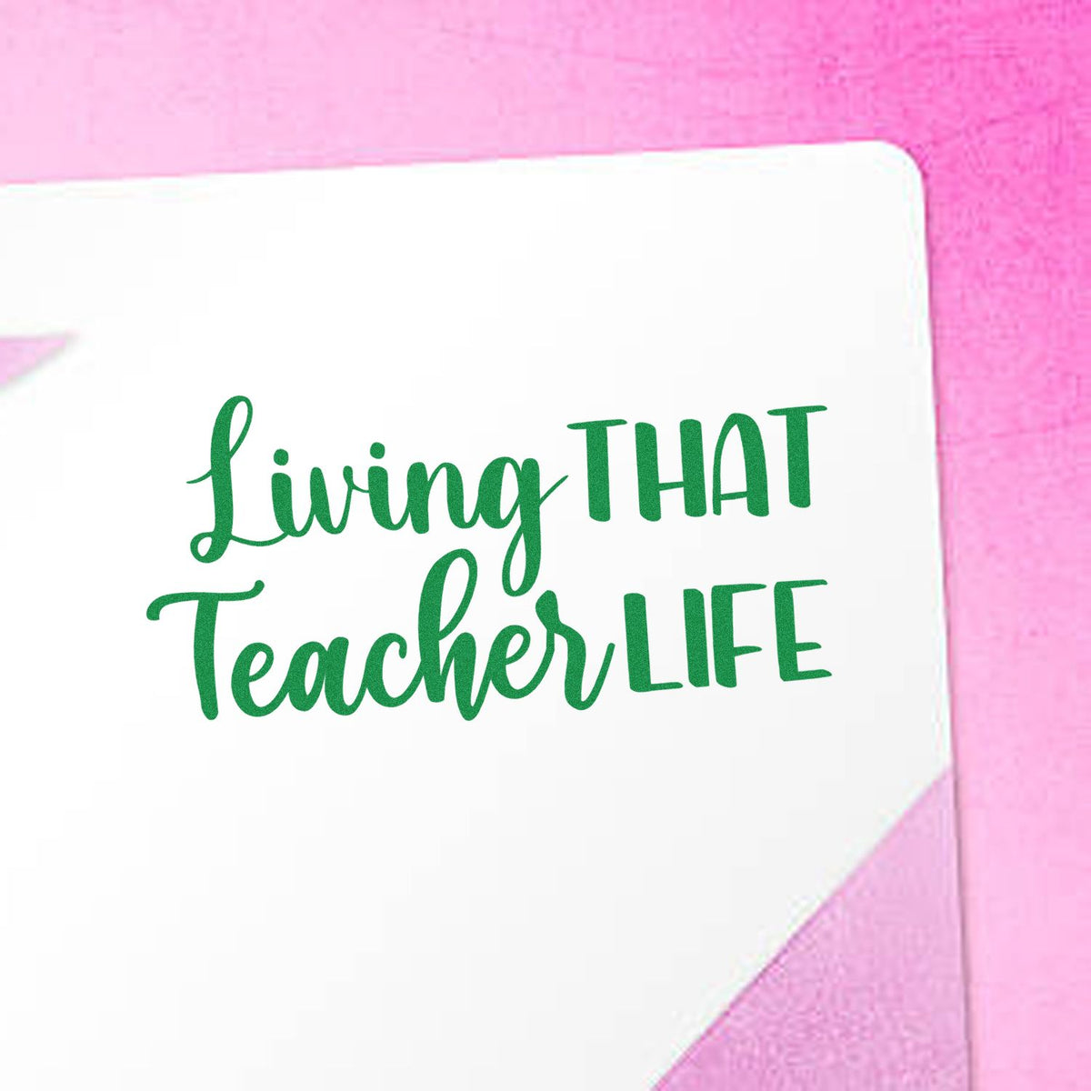 Green Living That Teacher Life stamp on a white square seal, set against a pink background.