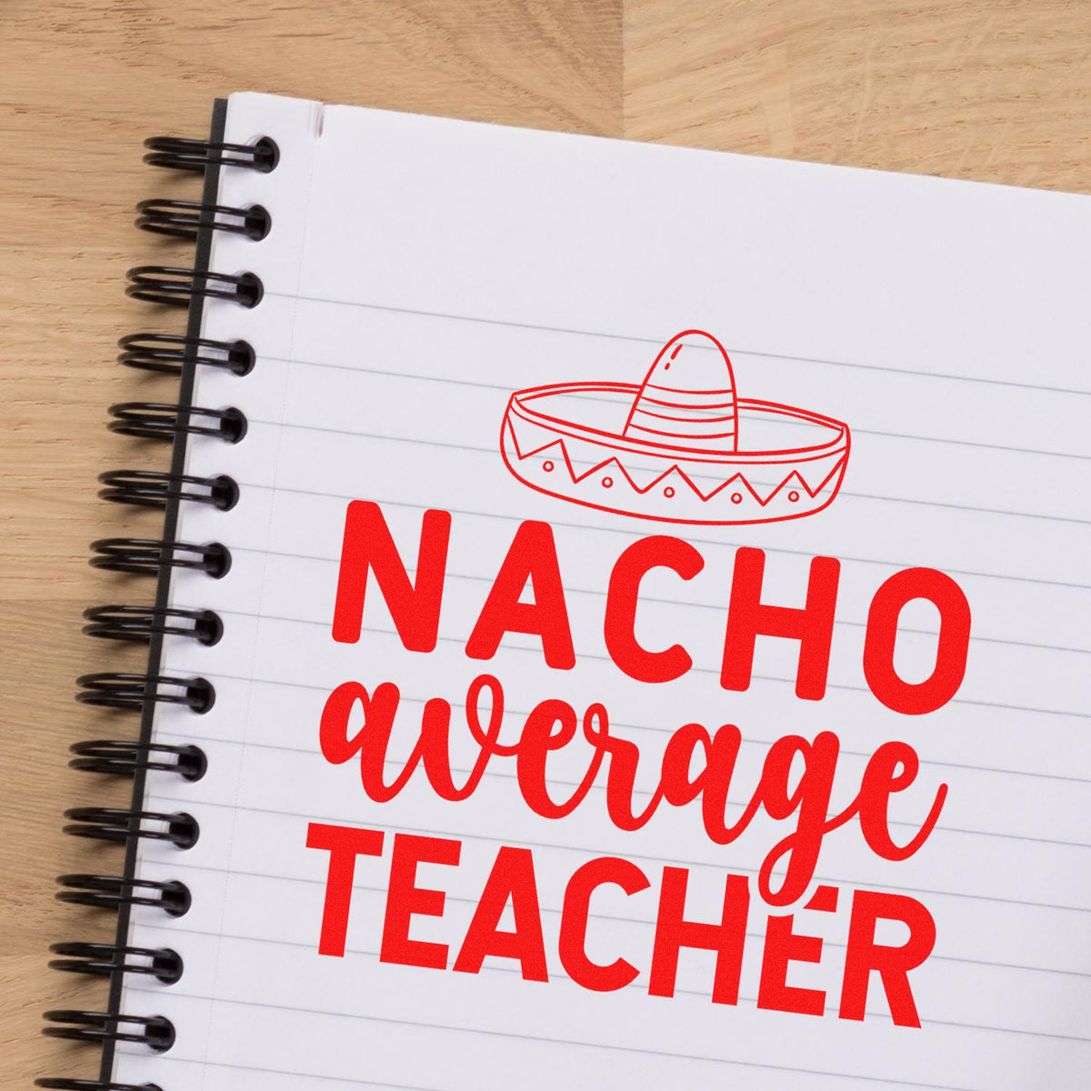 Red Nacho Average Teacher stamp with sombrero seal on a white spiral notebook page, bold red lettering and icon.